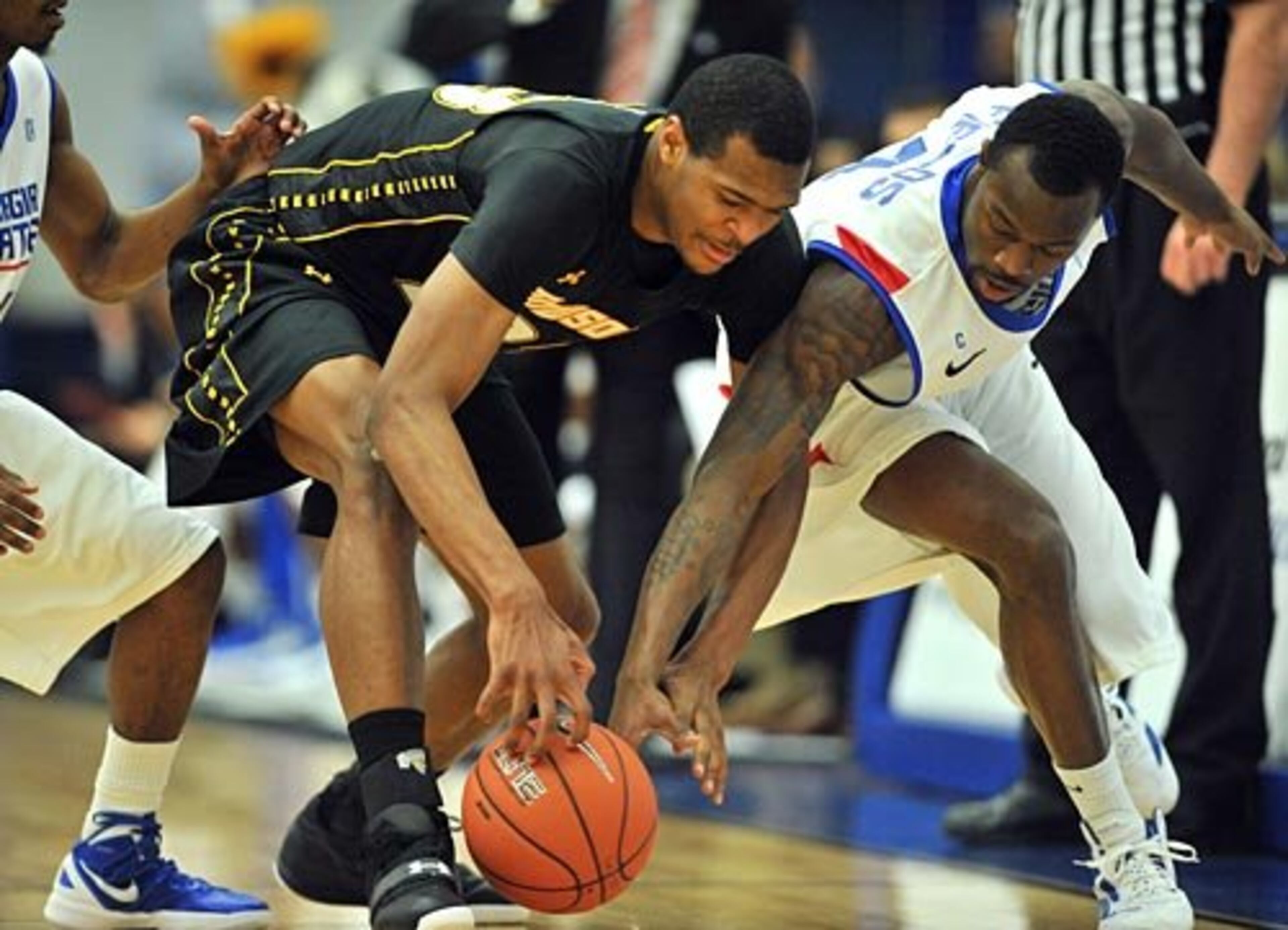 Towson forward Deon Jones (left) and Georgia State guard James Fields go for a loose ball.