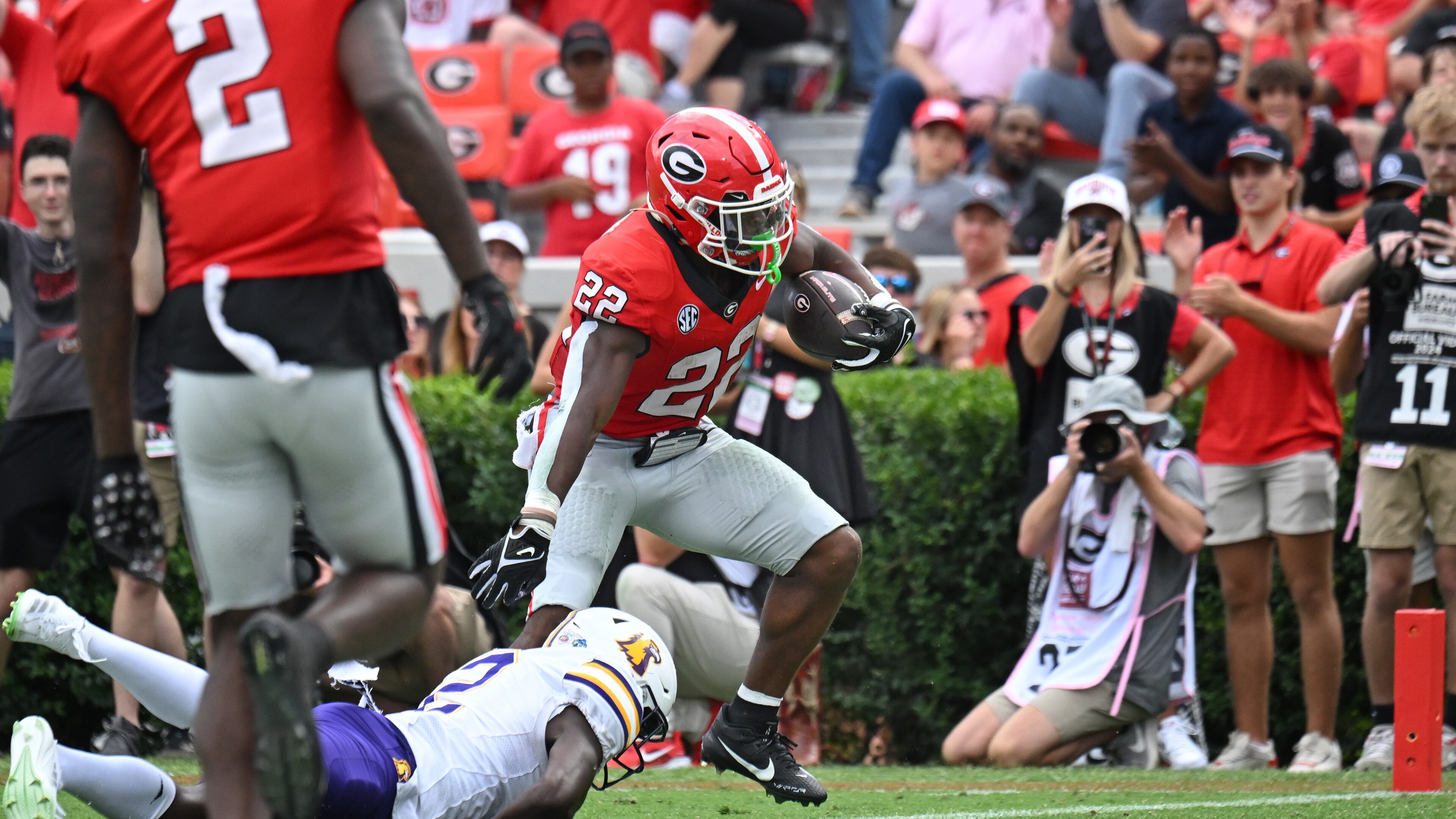 Georgia running back Branson Robinson (22) runs for a touchdown past Tennessee Tech defensive back James Edwards (2) during the second half in an NCAA football game at Sanford Stadium, Saturday, September 9, 2024, in Athens. Georgia won 48-3 over Tennessee Tech. (Hyosub Shin / AJC)