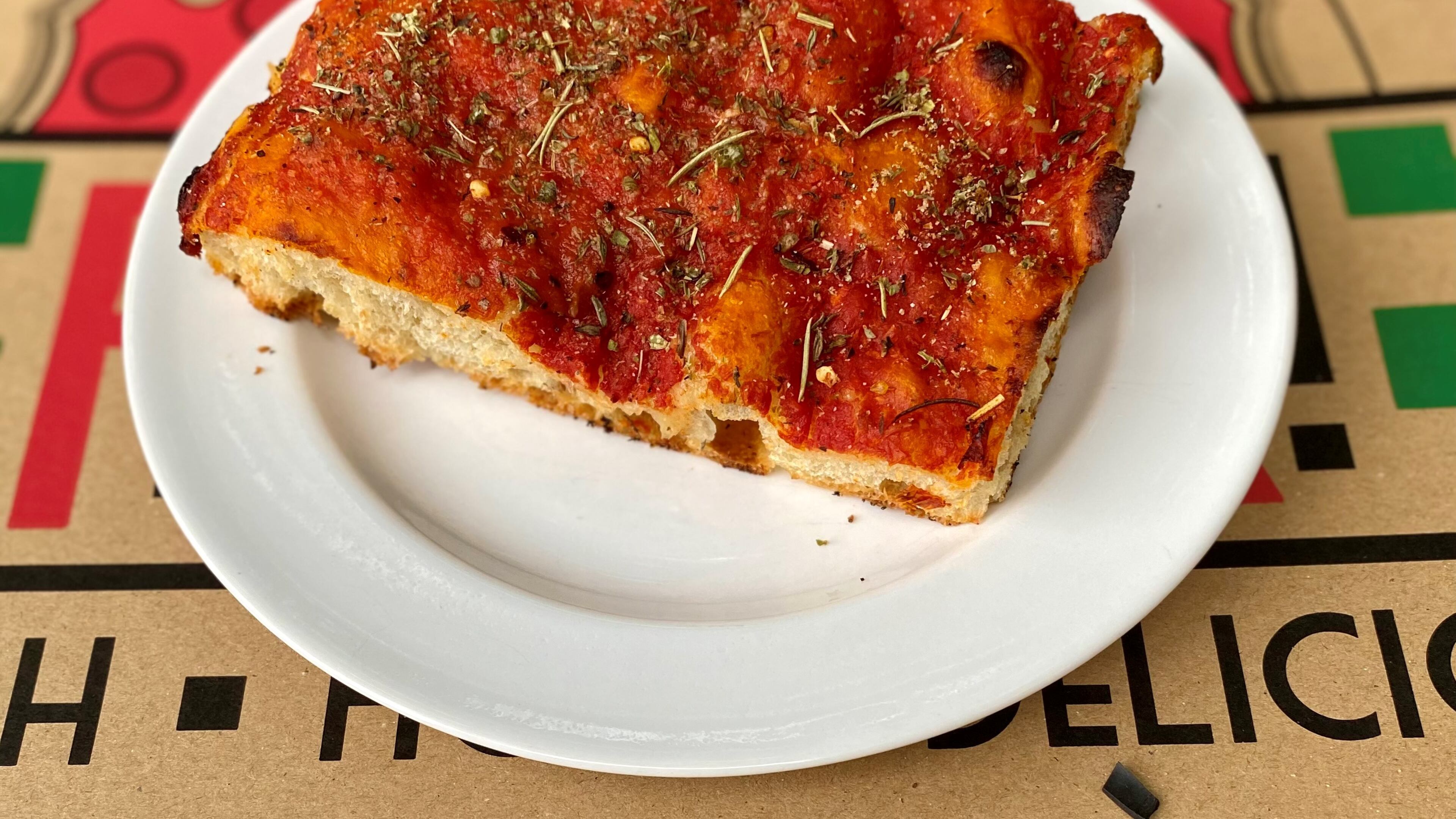 This is a slice of Ladrillo — aka grandma pie — from La Calavera Pizza. Ladrillo is the Spanish word for brick, and these heavy, red, rectangular slices do look a bit like red bricks. Wendell Brock for The Atlanta Journal-Constitution