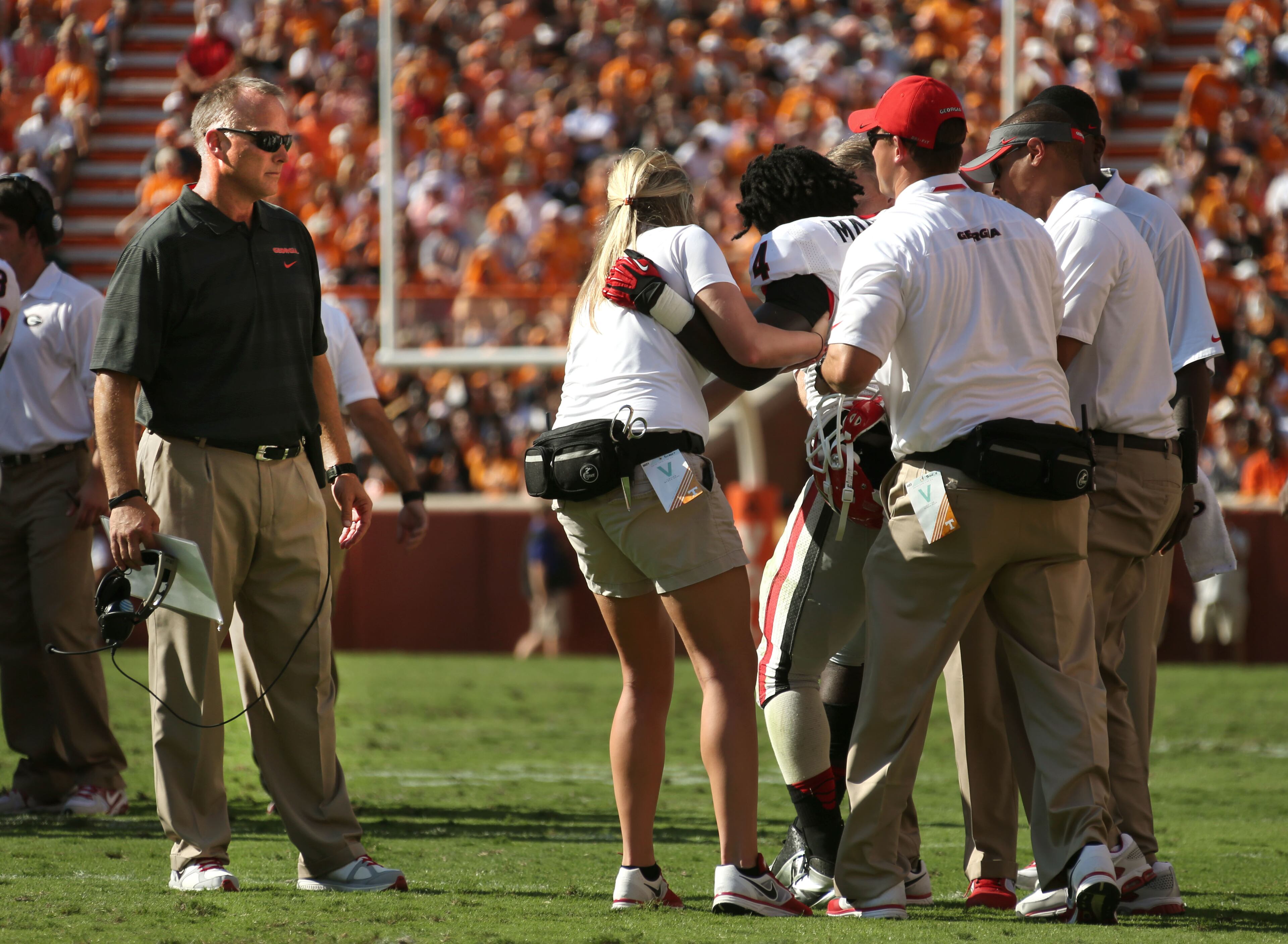 University of Georgia coach Mark Richt, left, watches as athletic trainers take Georgia Bulldogs running back Keith Marshall (4) off of the field after an injury that cost Marshall the rest of the season during their game against the University of Tennessee at Neyland Stadium Saturday afternoon in Knoxville, Tn., October 5, 2013. JASON GETZ / JGETZ@AJC.COM
