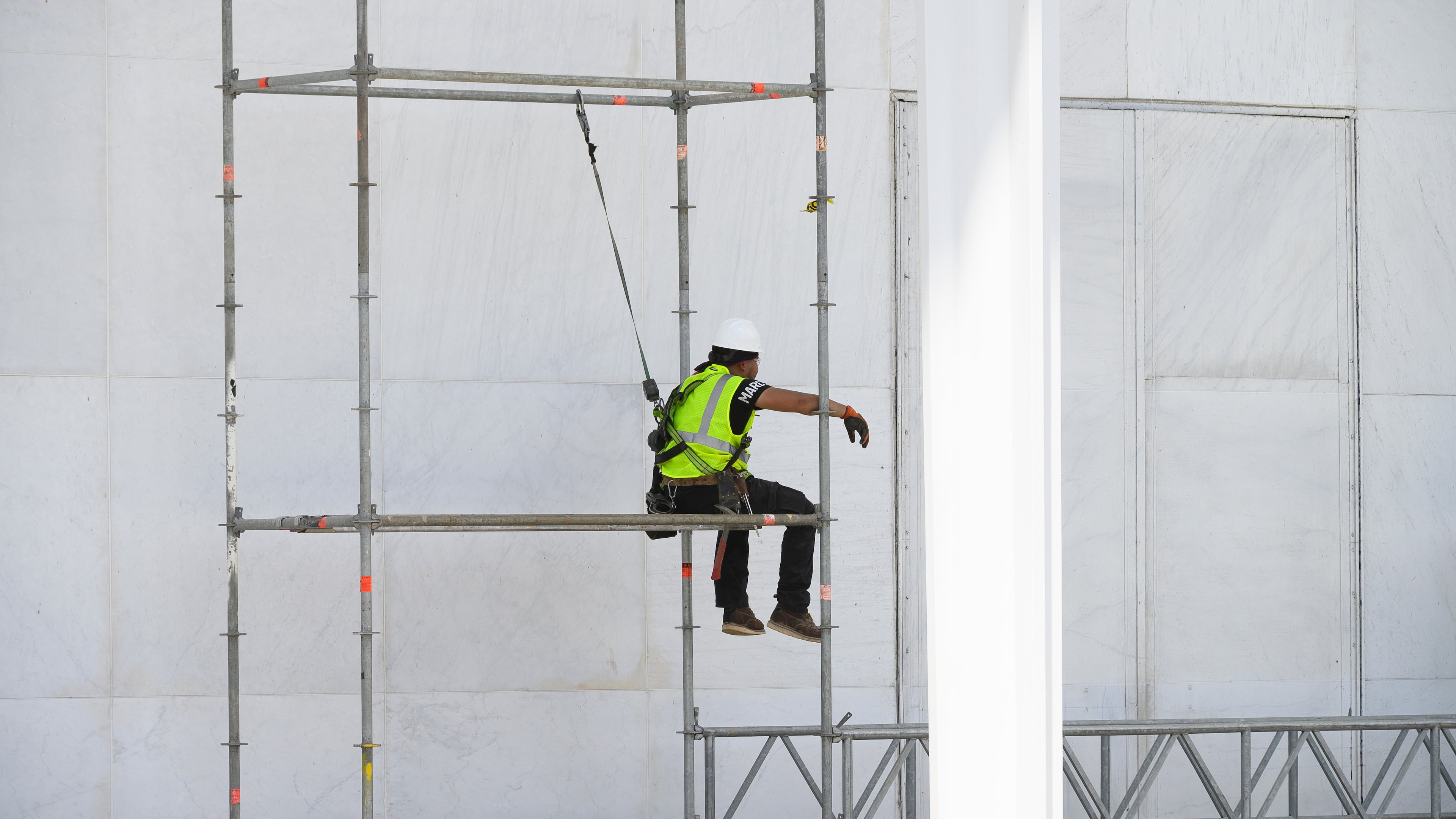 A worker sits on scaffolding at the John F. Kennedy Center for the Performing Arts in Washington, Friday, June 12, 2026. (AP Photo/Cliff Owen)