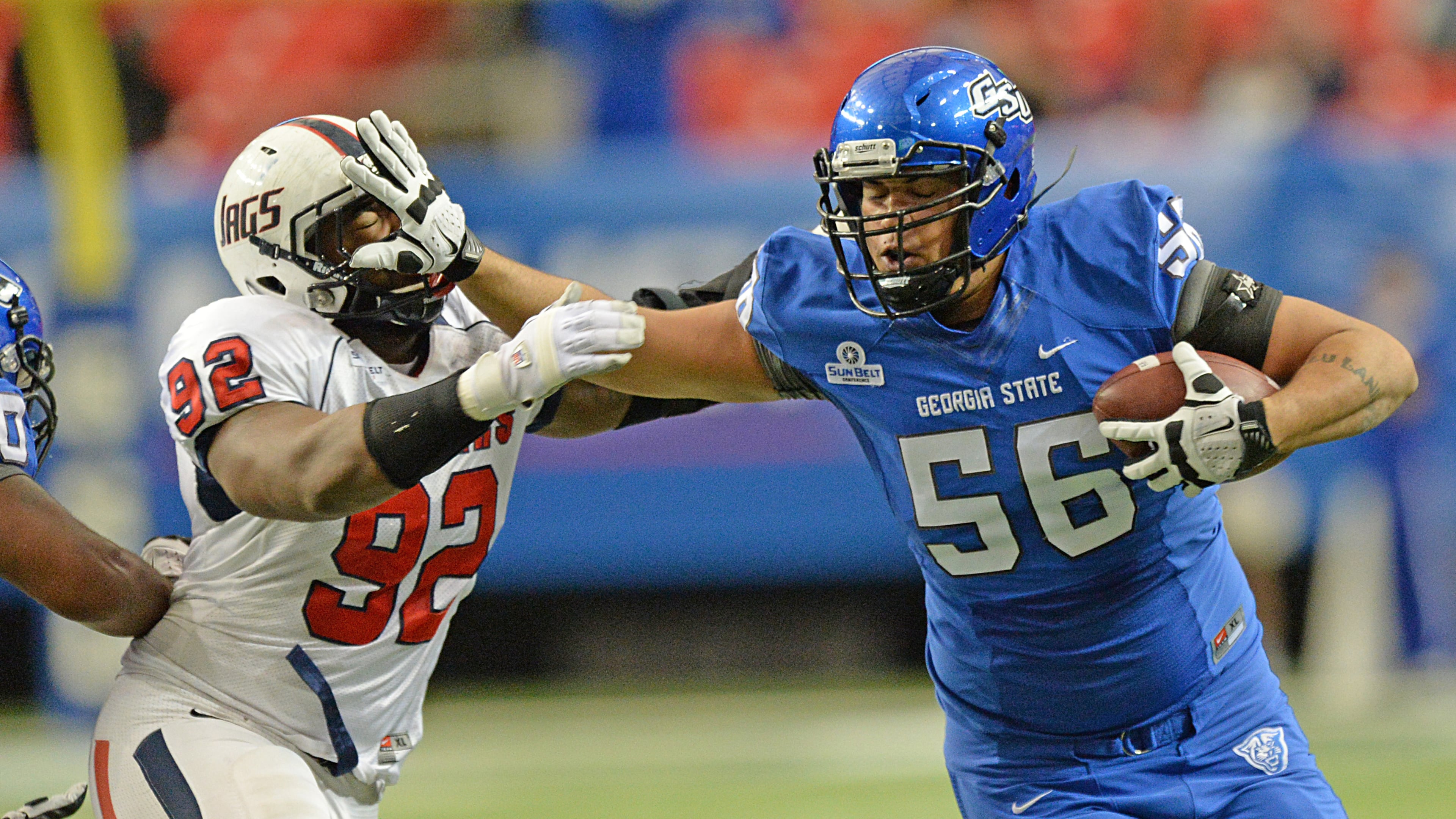 Georgia State Panthers offensive tackle Ulrick John (56) carries the ball against South Alabama Jaguars Montavious Williams (92) in the first half on Saturday, November 30, 2013, at the Georgia Dome.