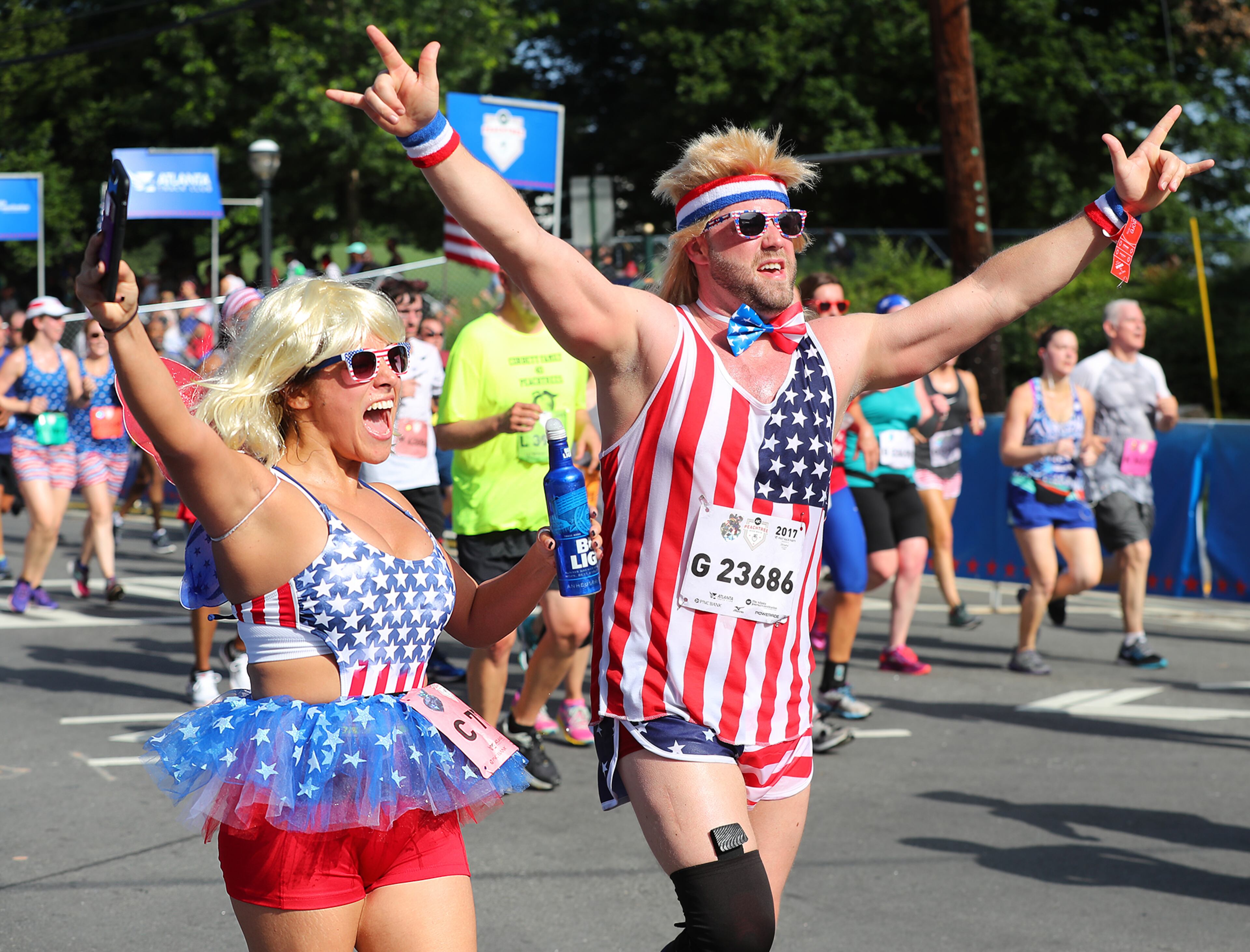 July 04, 2017 Atlanta: Alma Godoy and Tim Horn, Dalton, GA., sport patriotic attire cheering their way to the finish line during the 48th running of the AJC Peachtree Road Race on Tuesday, July 4, 2017, in Atlanta. Curtis Compton/ccompton@ajc.com