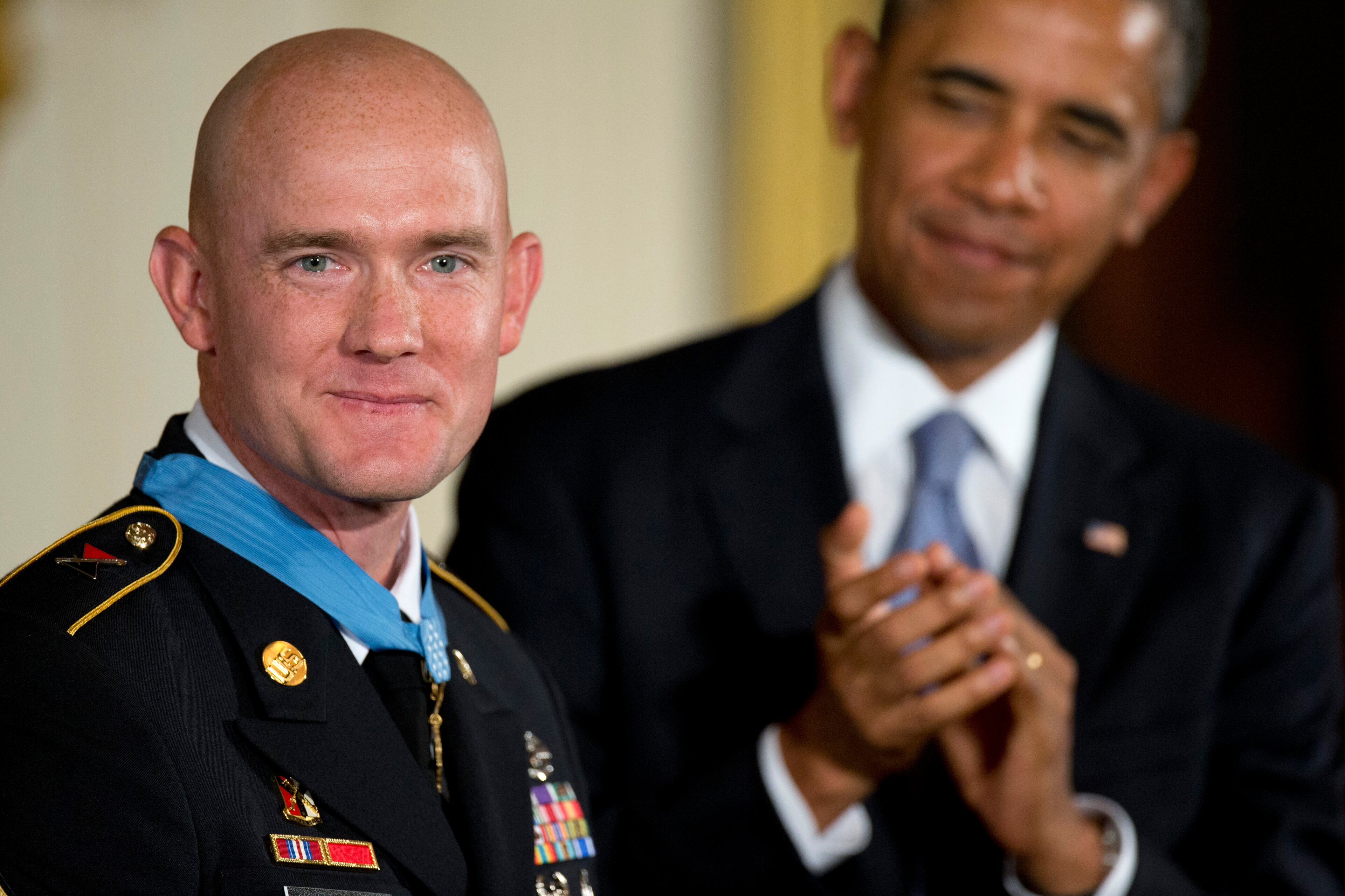 President Barack Obama looks at US Army Staff Sgt. Ty M. Carter and applauds after awarding him the Medal of Honor for conspicuous gallantry, Monday, Aug. 26, 2013, during a ceremony in the East Room of the White House in Washington. Carter received the medal for his courageous actions while serving as a cavalry scout with Bravo Troop, 3rd Squadron, 61st Cavalry Regiment, 4th Brigade Combat Team, 4th Infantry Division, during combat operations in Kamdesh District, Nuristan Province, Afghanistan on Oct. 3, 2009. Carter is the fifth living recipient to be awarded the Medal of Honor for actions in Iraq or Afghanistan. (AP Photo/Carolyn Kaster)