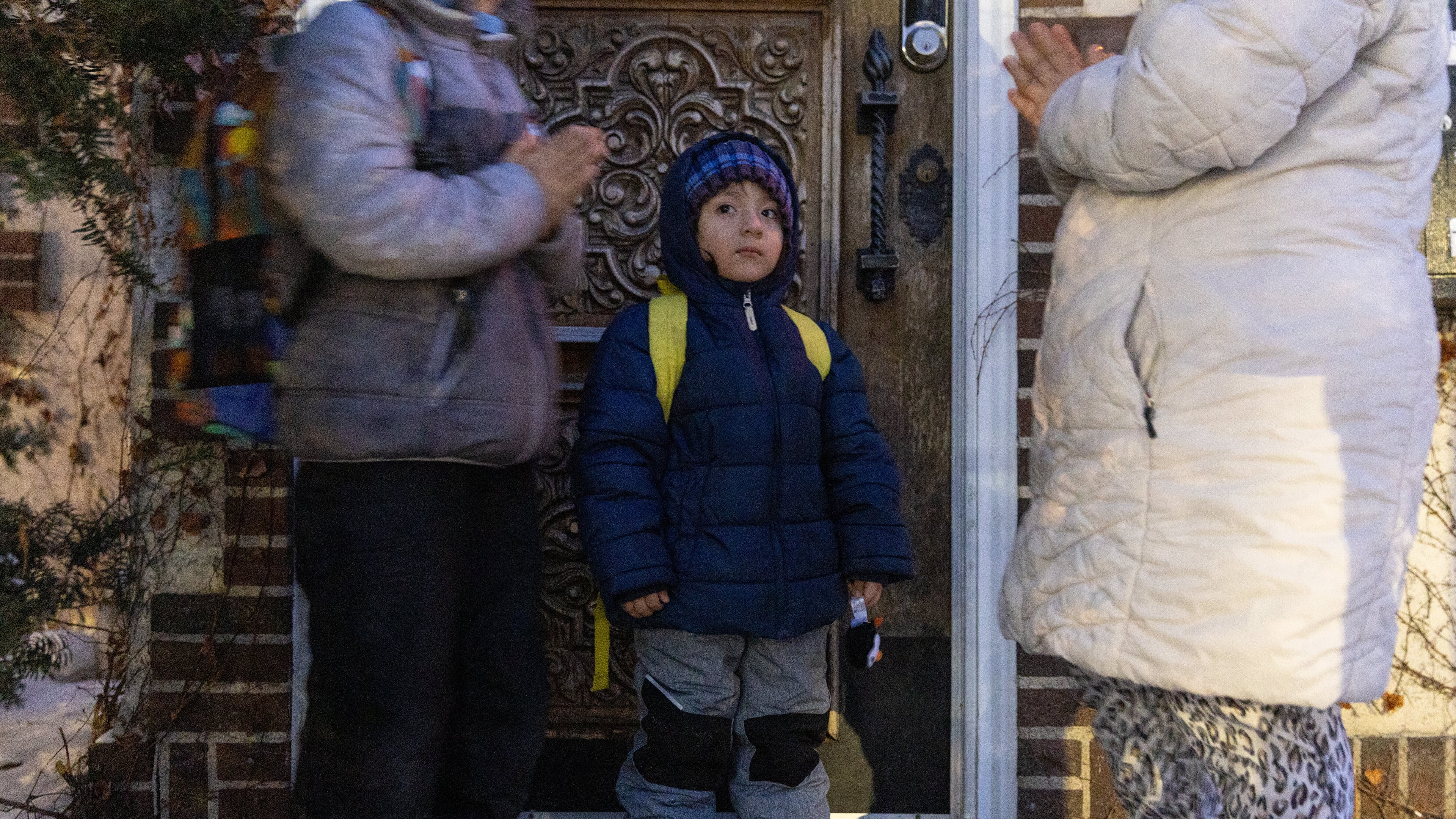 Giancarlo, 10, left, and Yair, 3, pray with their mom, right, before Giancarlo is picked up for school Tuesday, Feb. 3, 2026, in Minneapolis. (AP Photo/Liam James Doyle)