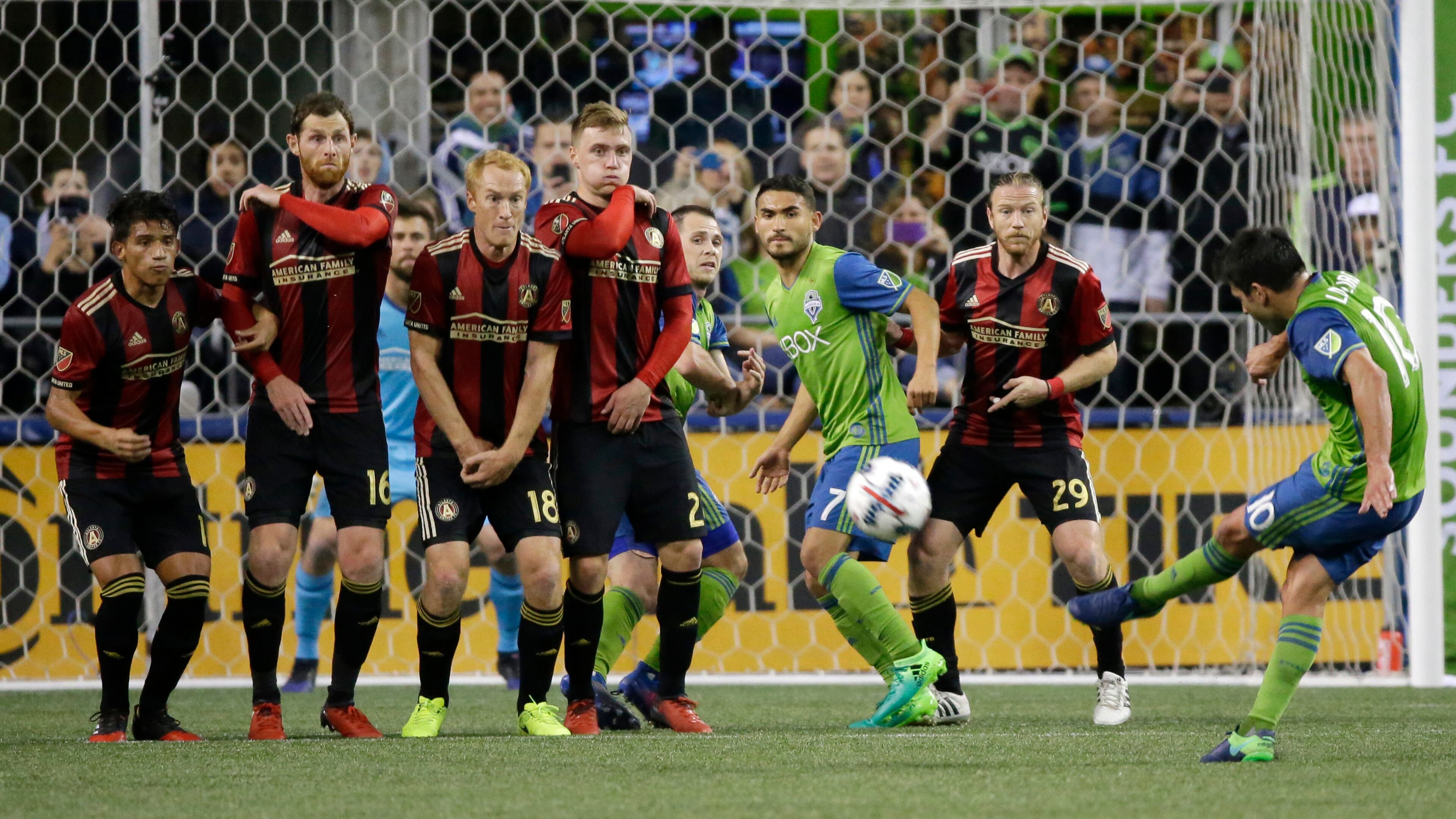 Atlanta United players make a wall as Seattle Sounders forward Nicolas Lodeiro, right, takes a free kick in the first half of an MLS soccer match, Friday, March 31, 2017, in Seattle. (AP Photo/Ted S. Warren)