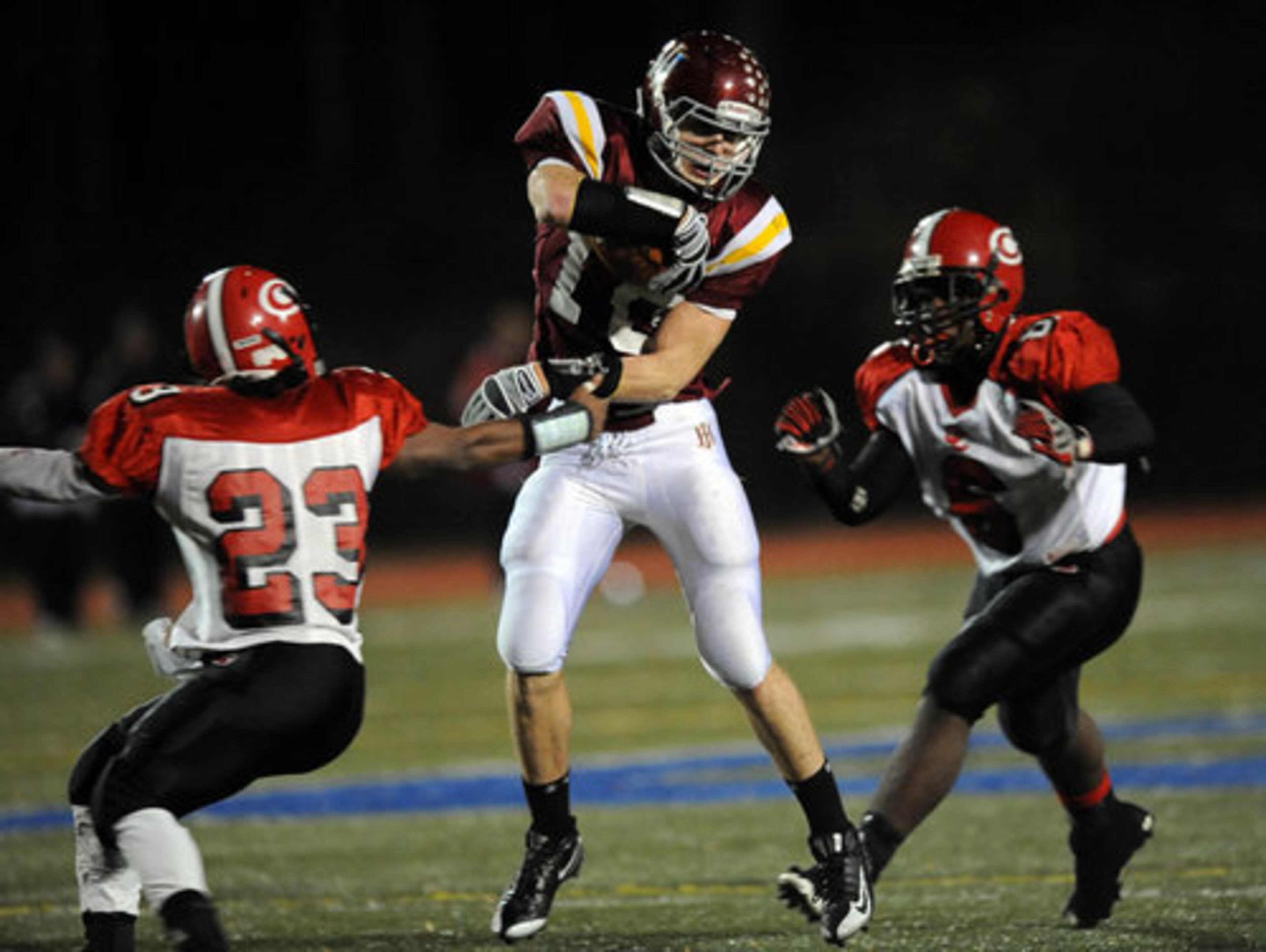 Holy Innocents' Jordan Miller (10) gets away from Clinch County's Trey Dorsey (23) and Trey Richardson.