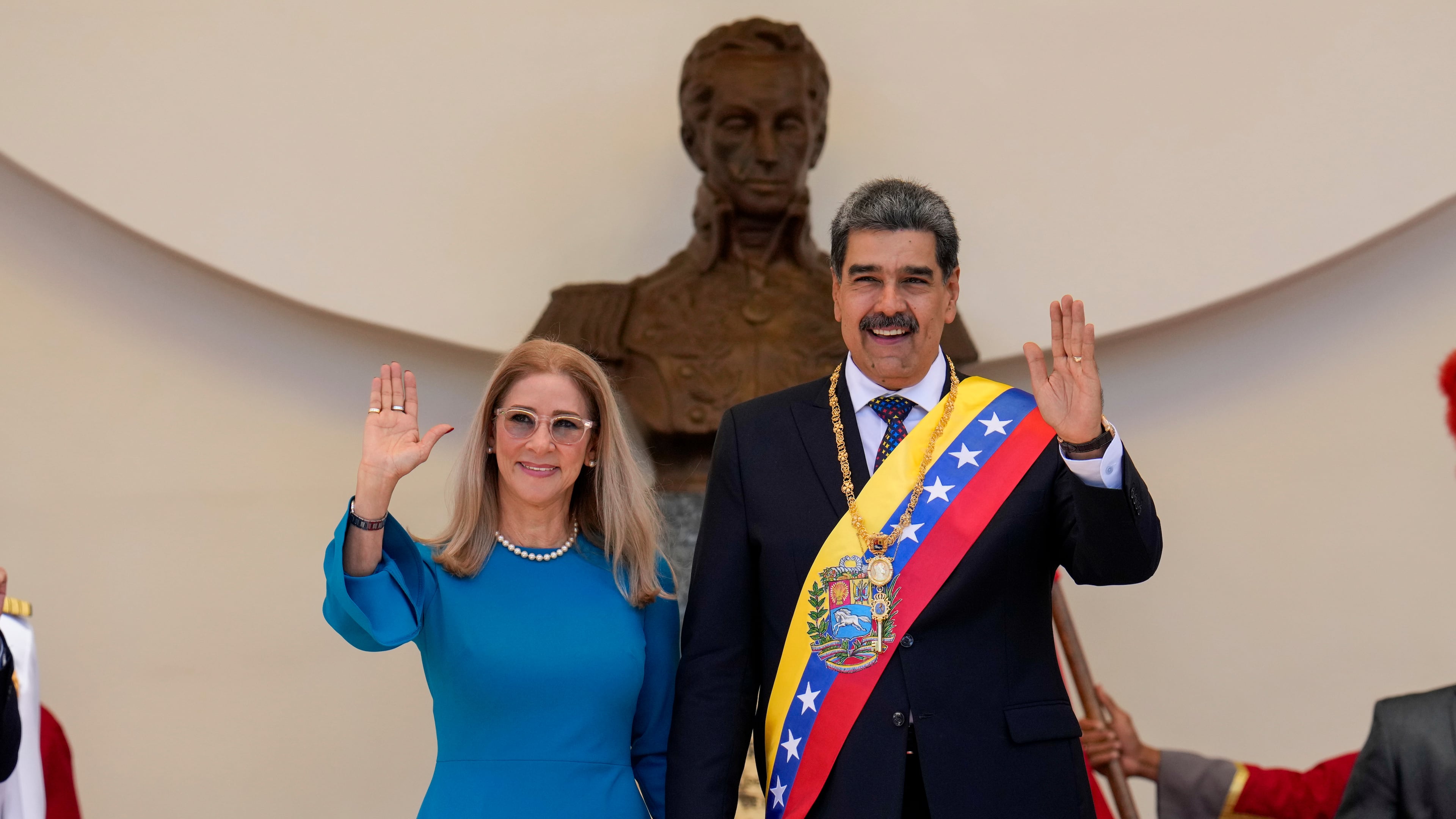 FILE - Venezuelan President Nicolas Maduro and his wife Cilia Flores wave after his swearing-in ceremony for a third term at the National Assembly in Caracas, Venezuela, on Jan. 10, 2025. (AP Photo/Ariana Cubillos, File)