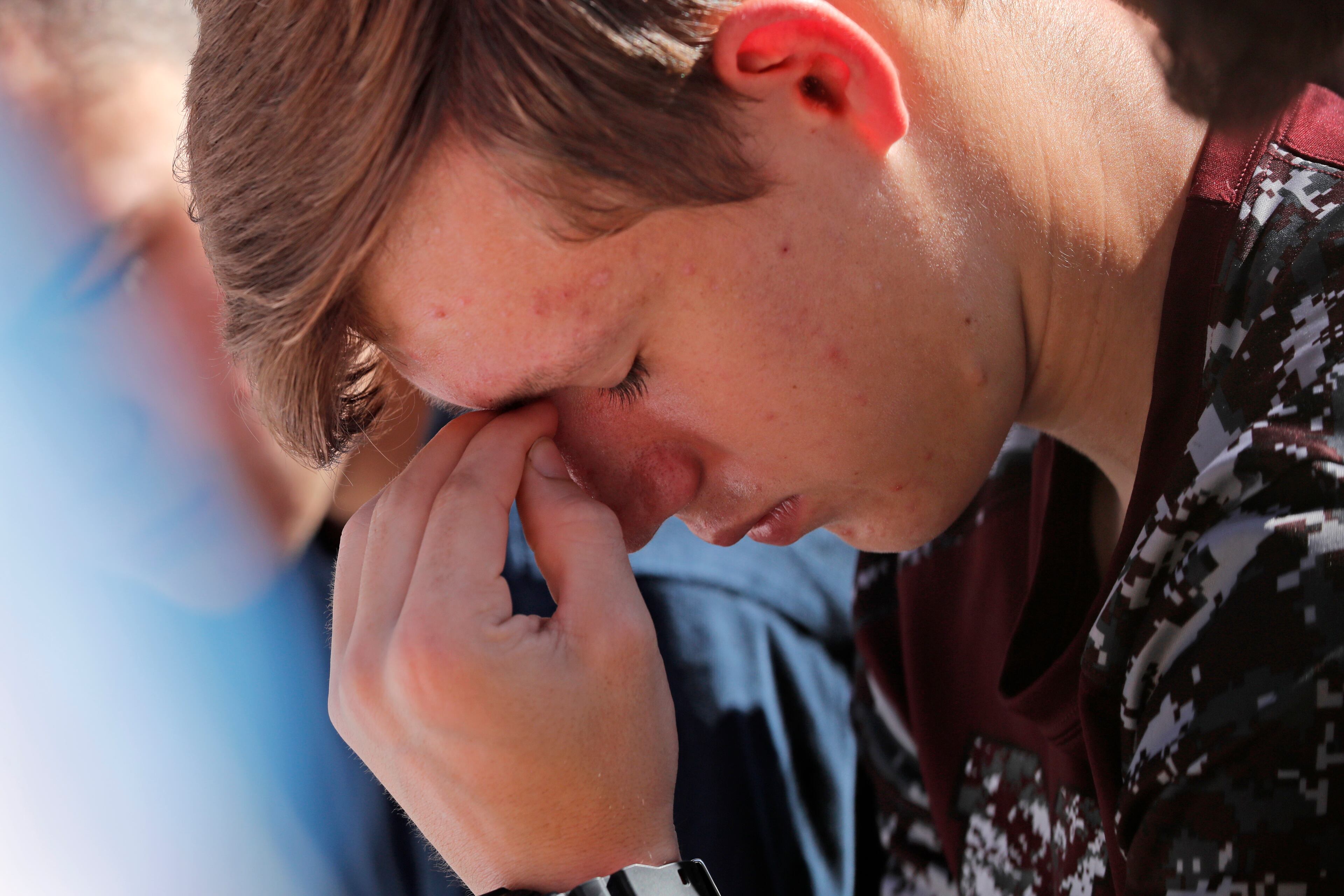 Ryan Schroy, 15, a student at Marjory Stoneman Douglas High School, bows in prayer during a vigil at the Parkland Baptist Church, for the victims of the Wednesday shooting at the school, in Parkland, Fla., Thursday, Feb. 15, 2018. Nikolas Cruz, a former student, was charged with 17 counts of premeditated murder on Thursday. (AP Photo/Gerald Herbert)