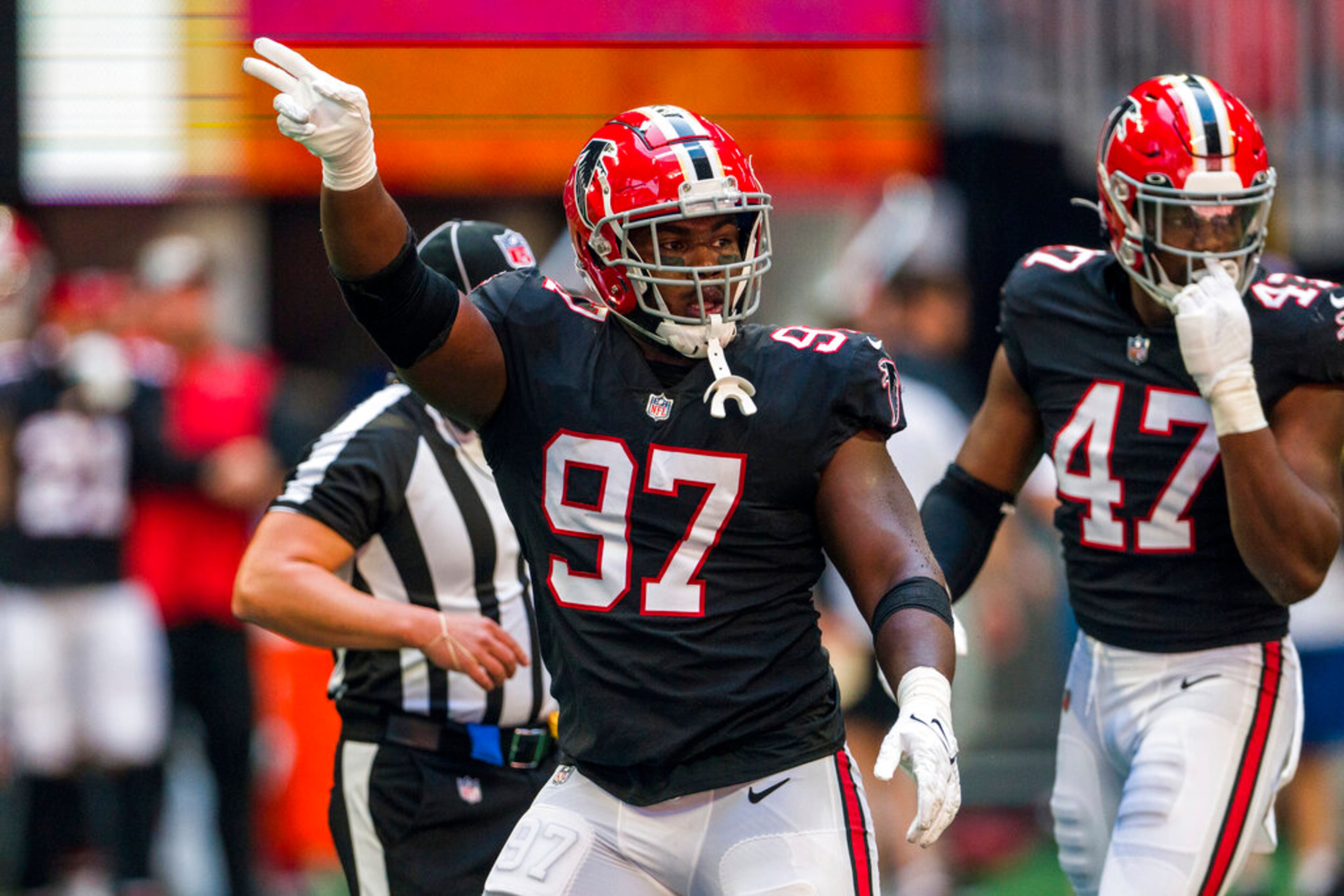 Atlanta Falcons defensive end Grady Jarrett (97) signals during the first half of an NFL football game against the San Francisco 49ers, Sunday, Oct. 16, 2022, in Atlanta. (AP Photo/Danny Karnik)