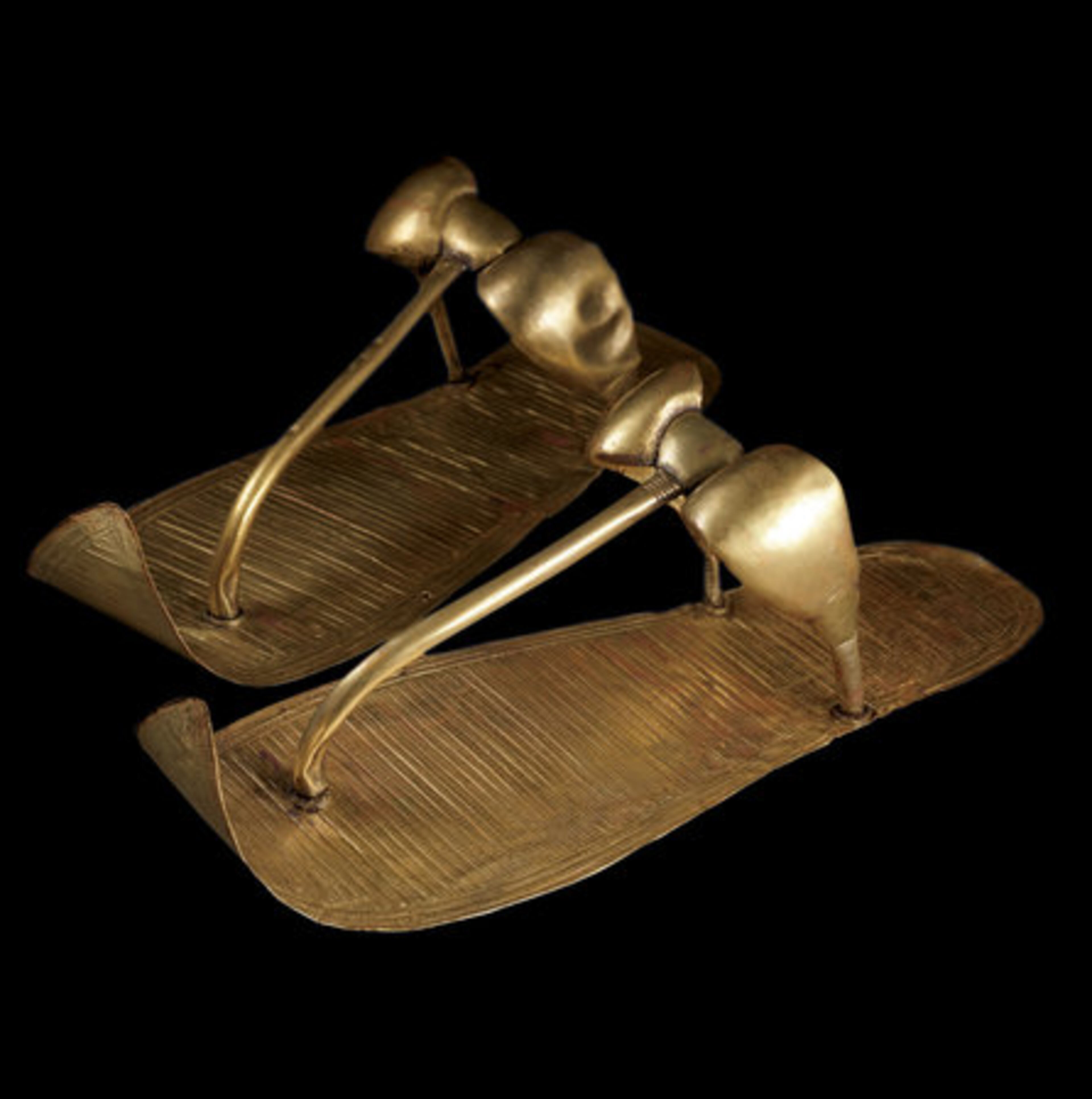 Tutankhamun's Golden Sandals: These golden sandals have engraved decoration that imitates woven reeds. Created specifically for the afterlife, they still covered the feet of Tutankhamun when Howard Carter unwrapped the mummy.