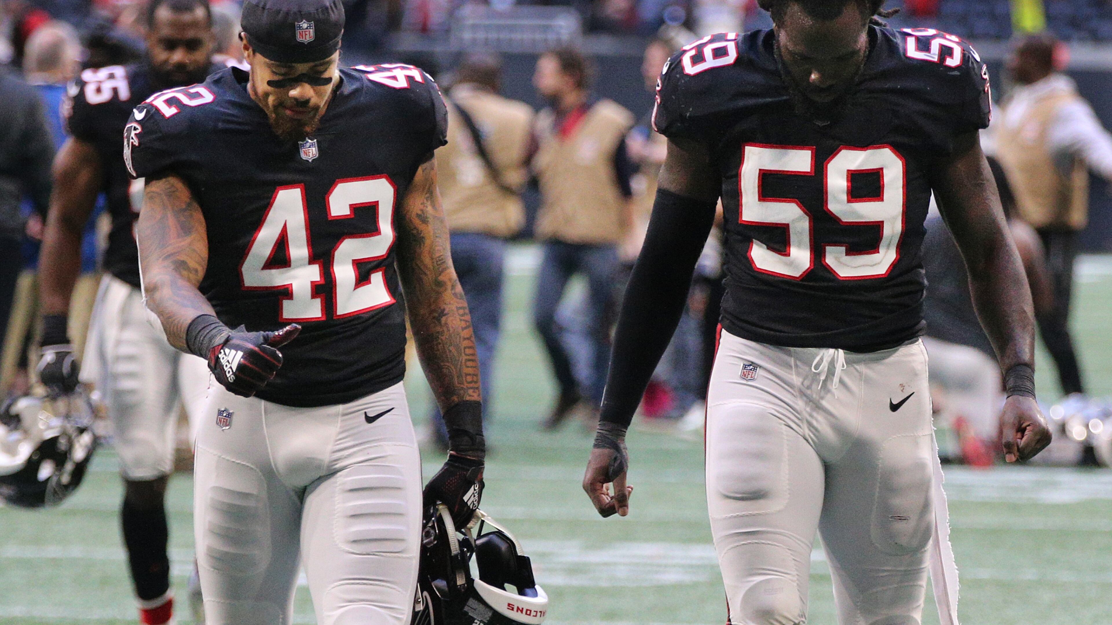 Atlanta Falcons linebackers Duke Riley (left) and De’Vondre Campbell walk off the field after falling to the Dallas Cowboys 22-19 on Sunday, Nov. 18, 2018, in Atlanta.