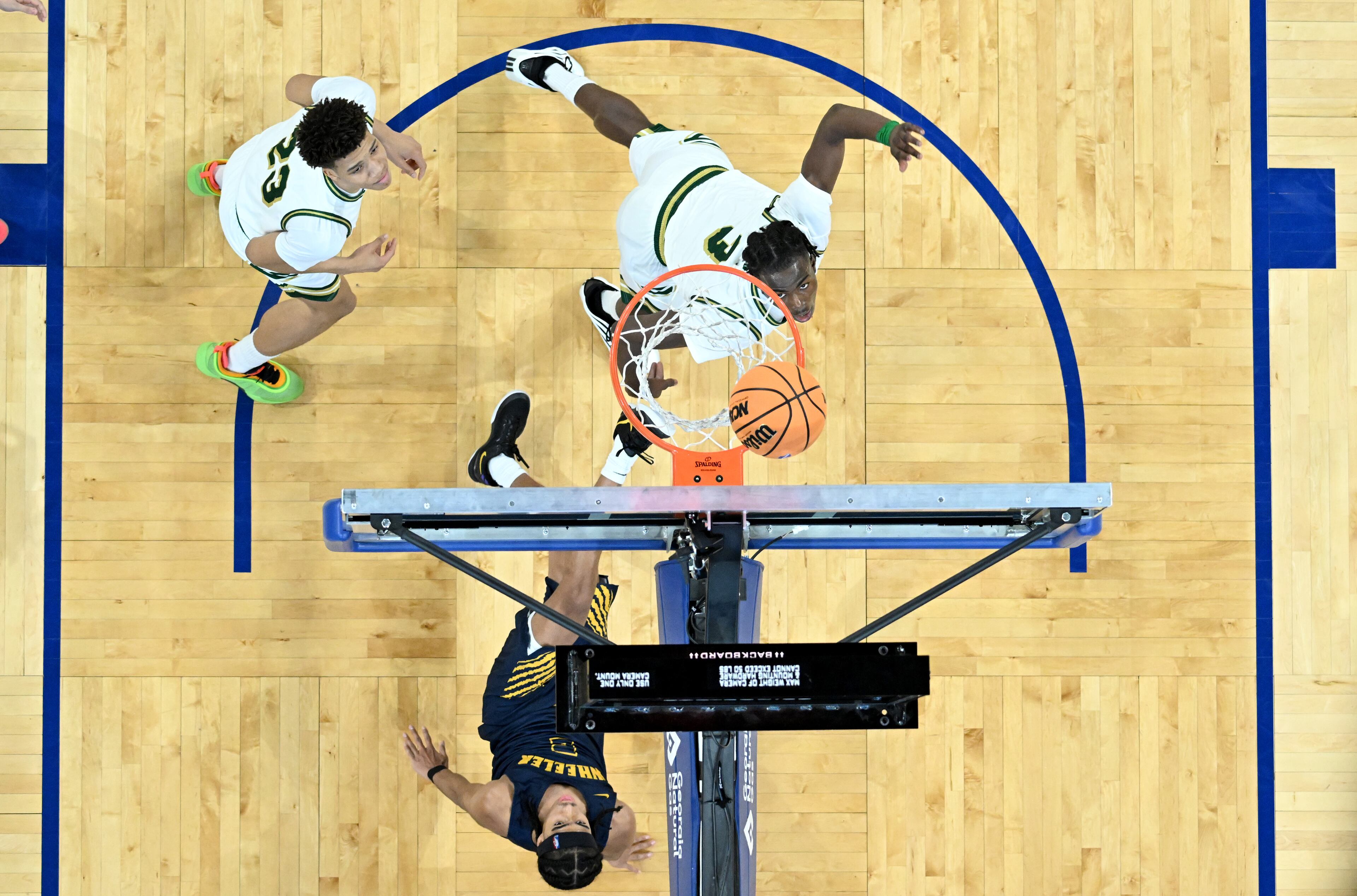 Wheeler's Kevin Savage (2) falls as he scores during the second half of the GHSA Class 6A Boys State Basketball playoffs game at the Georgia State Convocation Center, Saturday, March 1, 2025, in Atlanta. Wheeler won 68-53 over Grayson. (Hyosub Shin / AJC)