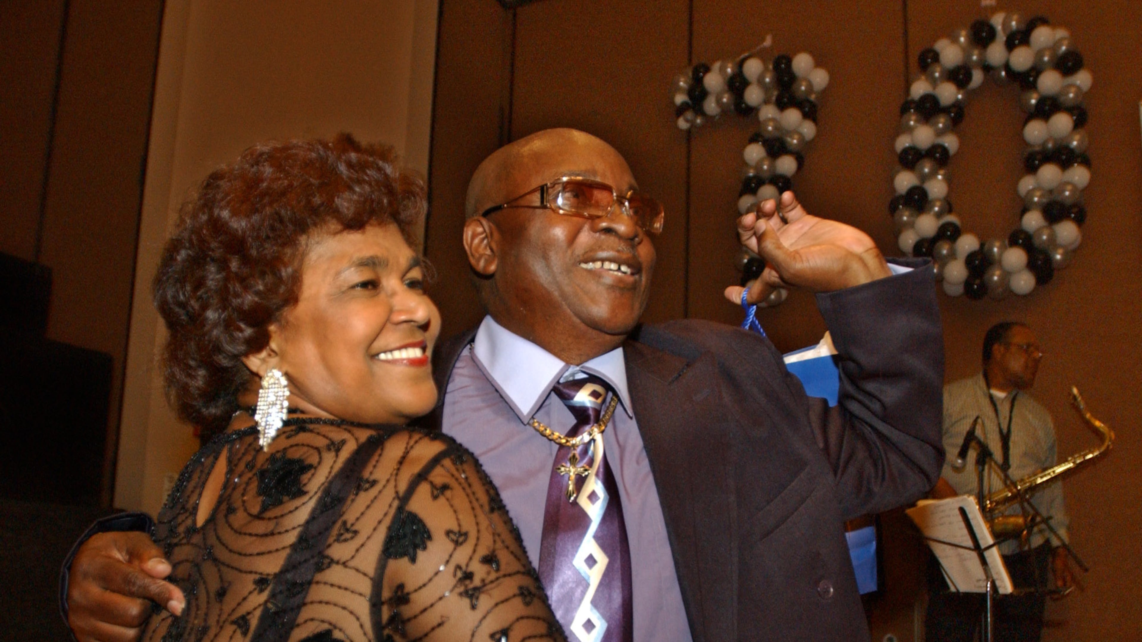 FILE - Calypso star, Slinger Francisco, otherwise known as 'The Mighty Sparrow,' right, celebrates his 70th birthday dancing calypso with Caribbean community leader Jean Alexander at a reception in his honor in the Brooklyn borough of New York, July 29, 2005. (AP Photo/Jennifer Szymaszek, File)