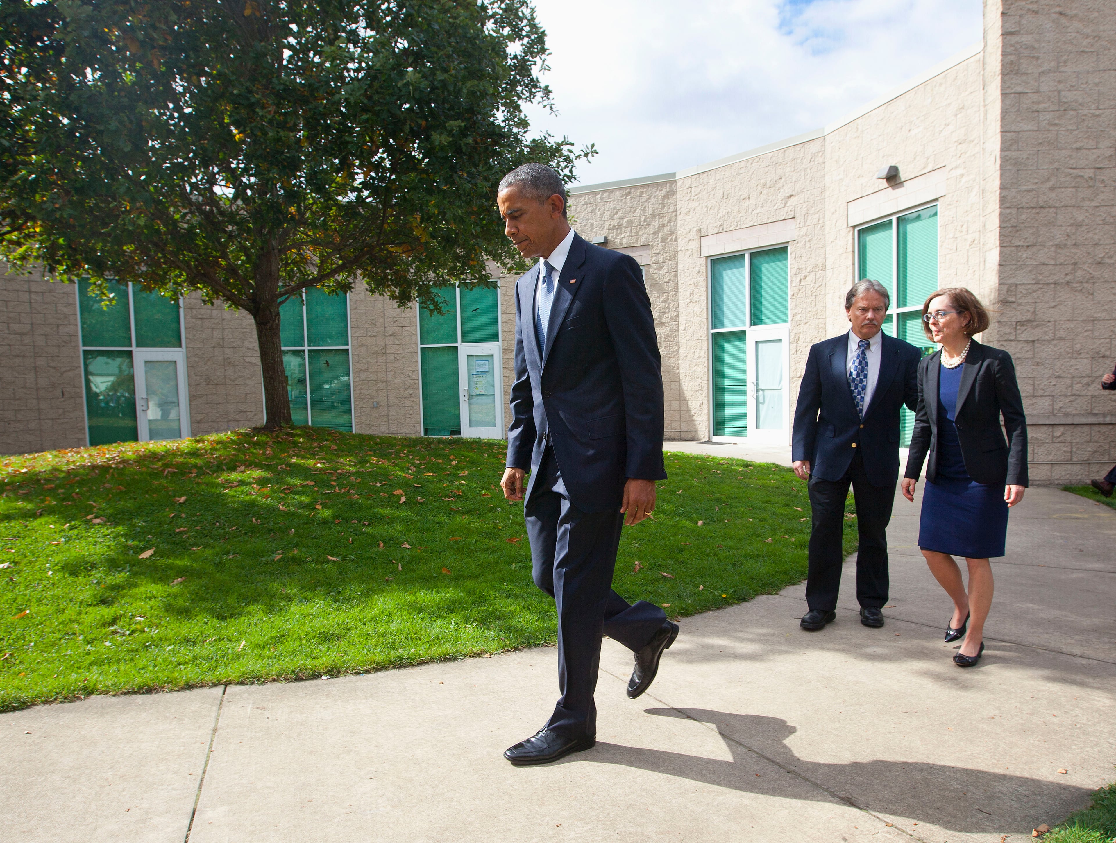 President Barack Obama followed by Roseburg, Ore. Mayor Larry Rich and Oregon Gov. Kate Brown walk away together after making statement to members of the media following their meeting with families of the victims of the Oct. 1, shooting at Umpqua Community College, Friday, Oct. 9, 2015 in Roseburg, Ore. (AP Photo/Pablo Martinez Monsivais)