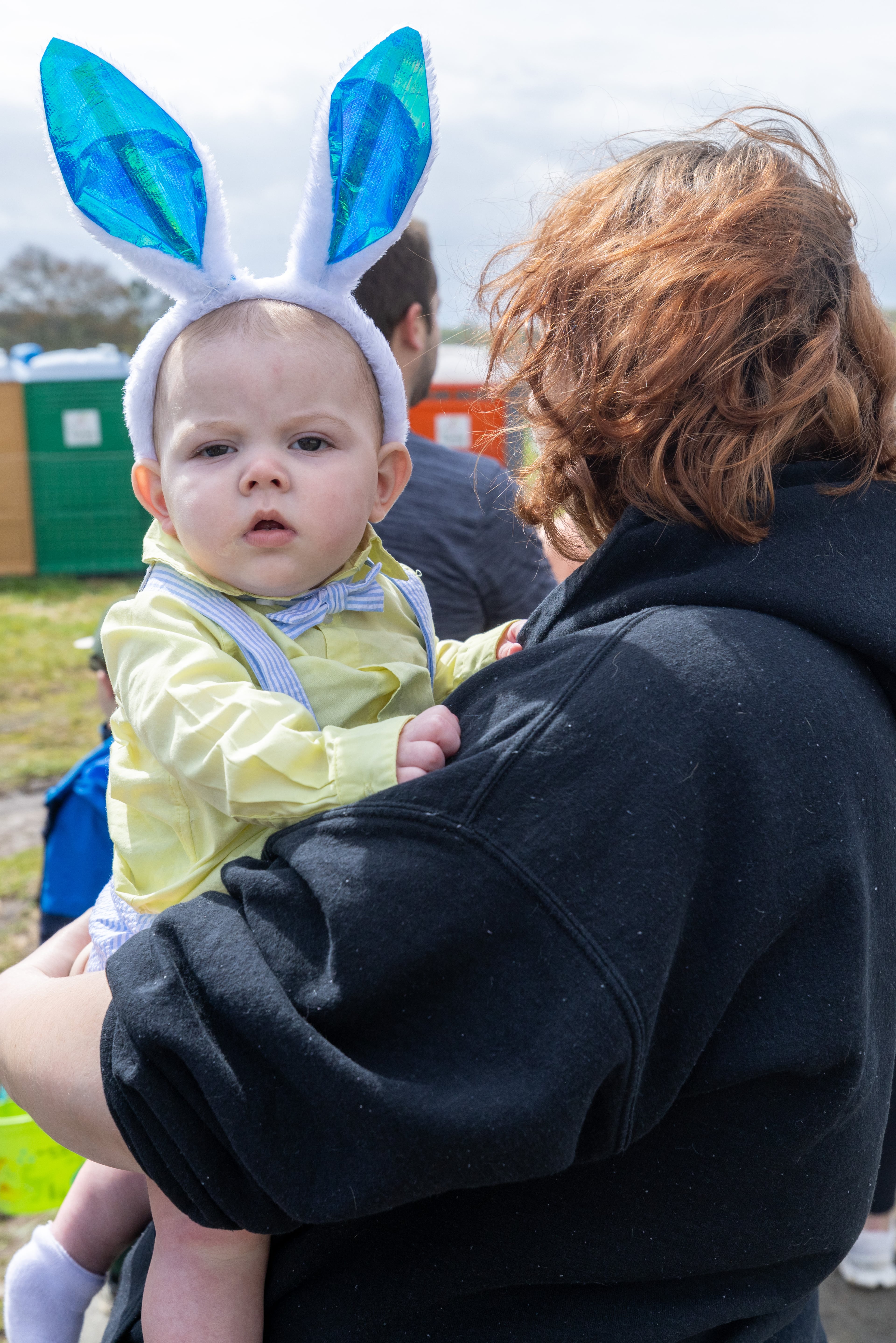 Caitlyn Hamby holds her son Truen as they stand in line to get into the Homer Easter Egg Hunt “In Celebration of Mack Garrison" in Homer, Georgia on Saturday, April 1, 2023. The Garrison family started the annual tradition in 1959, which would become known as Georgia's largest Easter egg hunt, with more than 100,000 candy eggs.(Steve Schaefer/steve.schaefer@ajc.com)