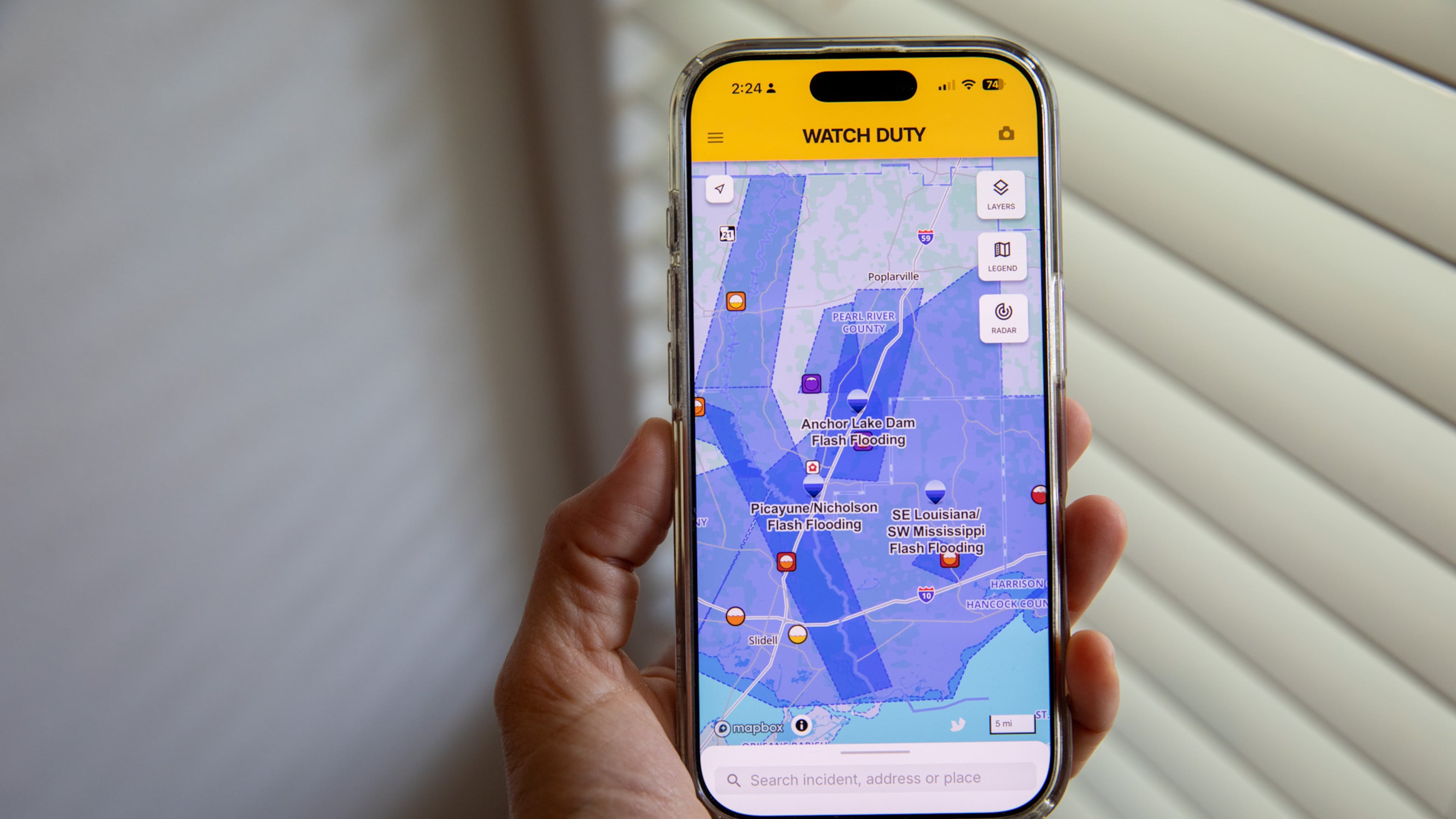 A person uses the Watch Duty app to track floods, Thursday, June 18, 2026, in San Diego, Calif. (AP Photo/Gabriela Aoun Angueira)