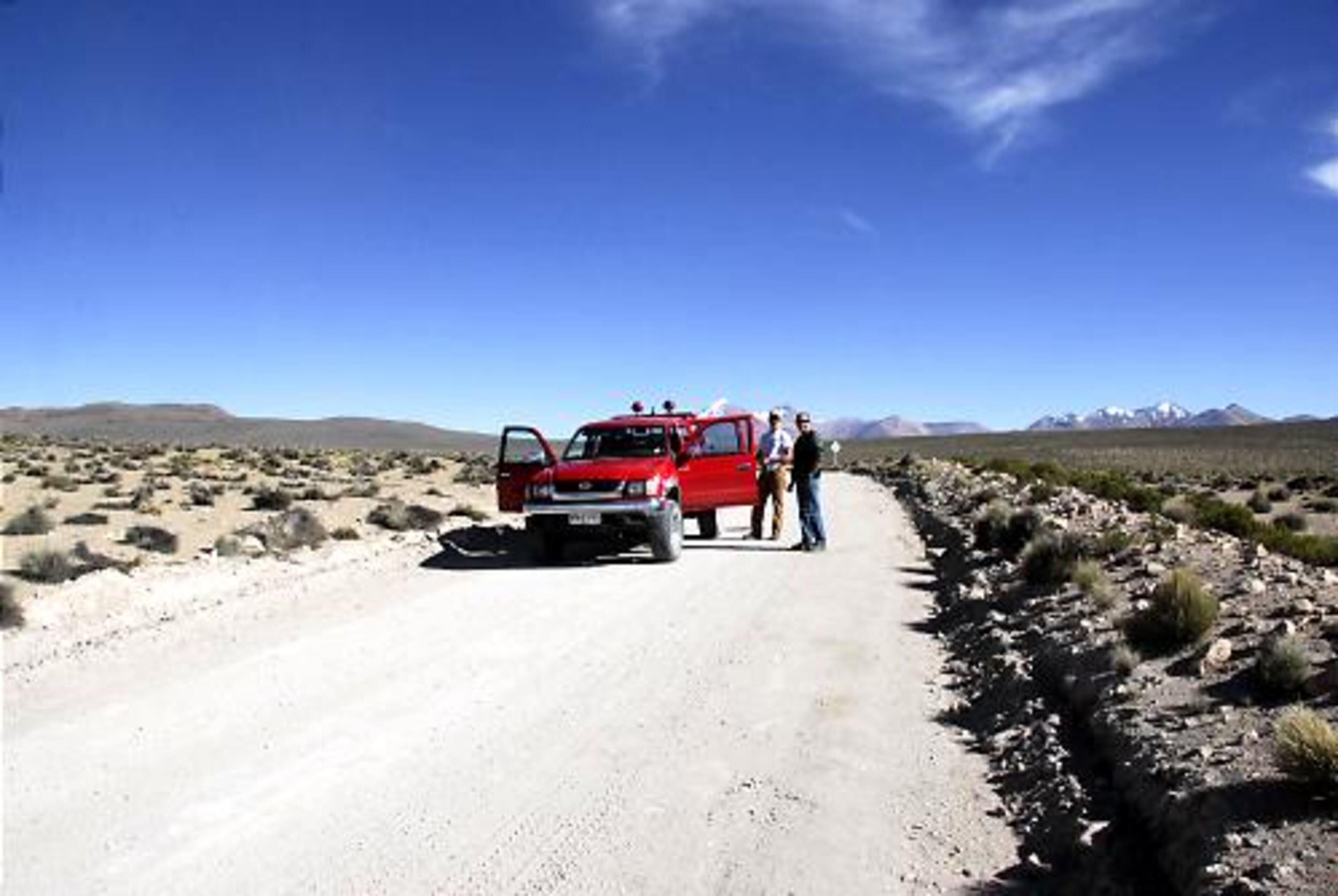 The high desert is an open expanse of hearty grasses sandwiched between a dome of blue sky and a surrounding ring of volcanic peaks.