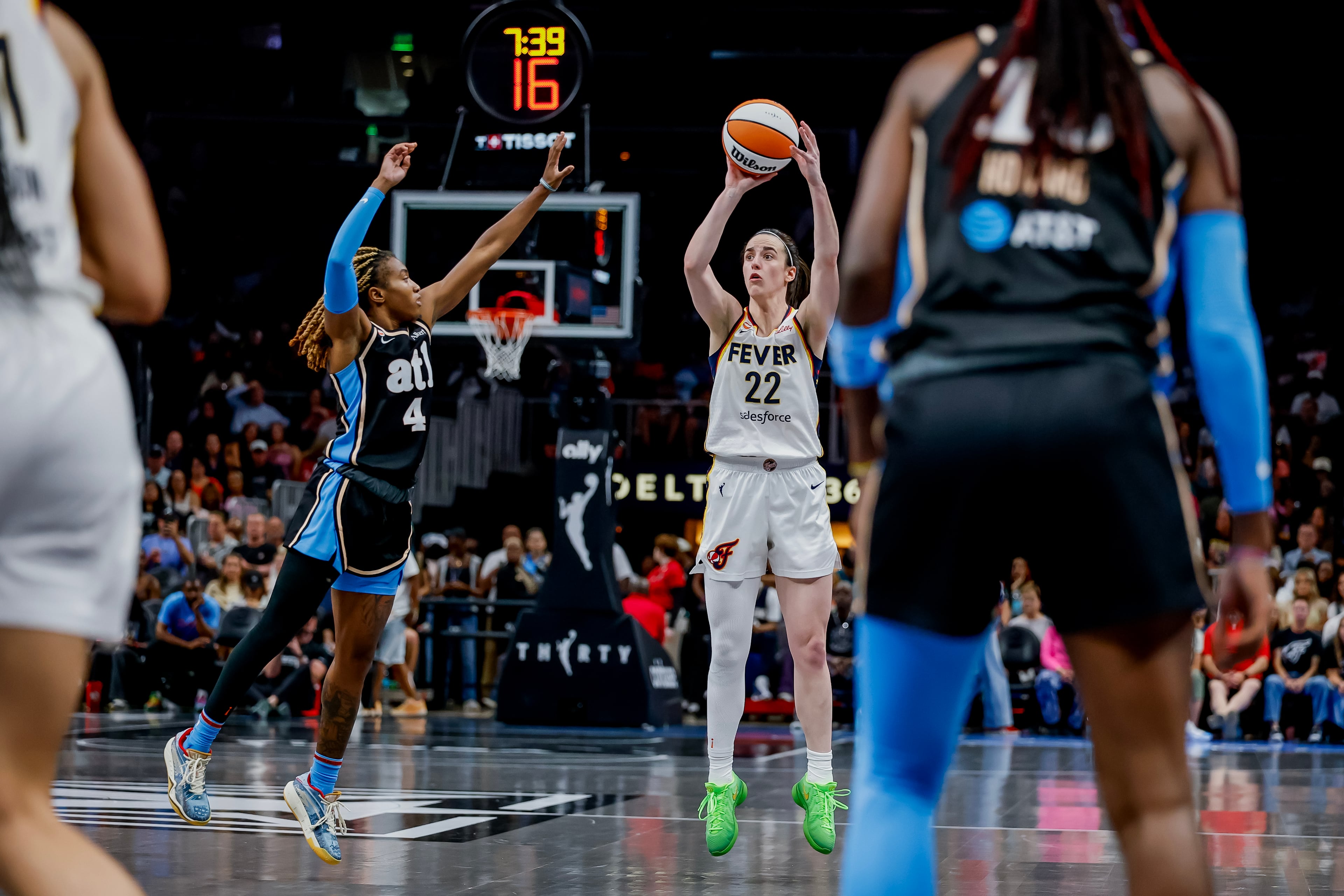 Clark (right) shoots against Sherrod. Clark, despite shooting just 3-for-10 from 3-point range, led the Fever with 26 points and 9 assists. (Erik S. Lesser for the AJC)