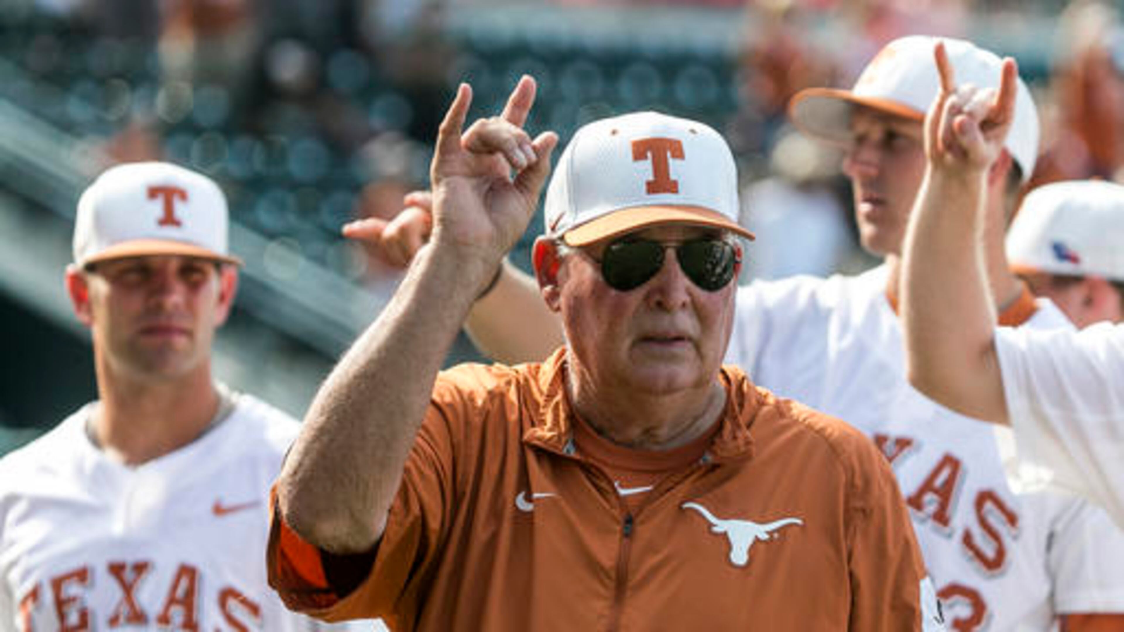 FILE - In this Saturday, May 21, 2016, file photo, Texas coach Augie Garrido sings "The Eyes of Texas" with the team after Texas defeated Baylor 7-6 in an NCAA college baseball game in Austin, Texas. Garrido, the winningest coach in college baseball history, is out after 20 seasons at Texas. The decision Monday, May 30, 2016, comes after the Longhorns' first losing season since 1998. . (Rodolfo Gonzalez/Austin American-Statesman via AP, File)