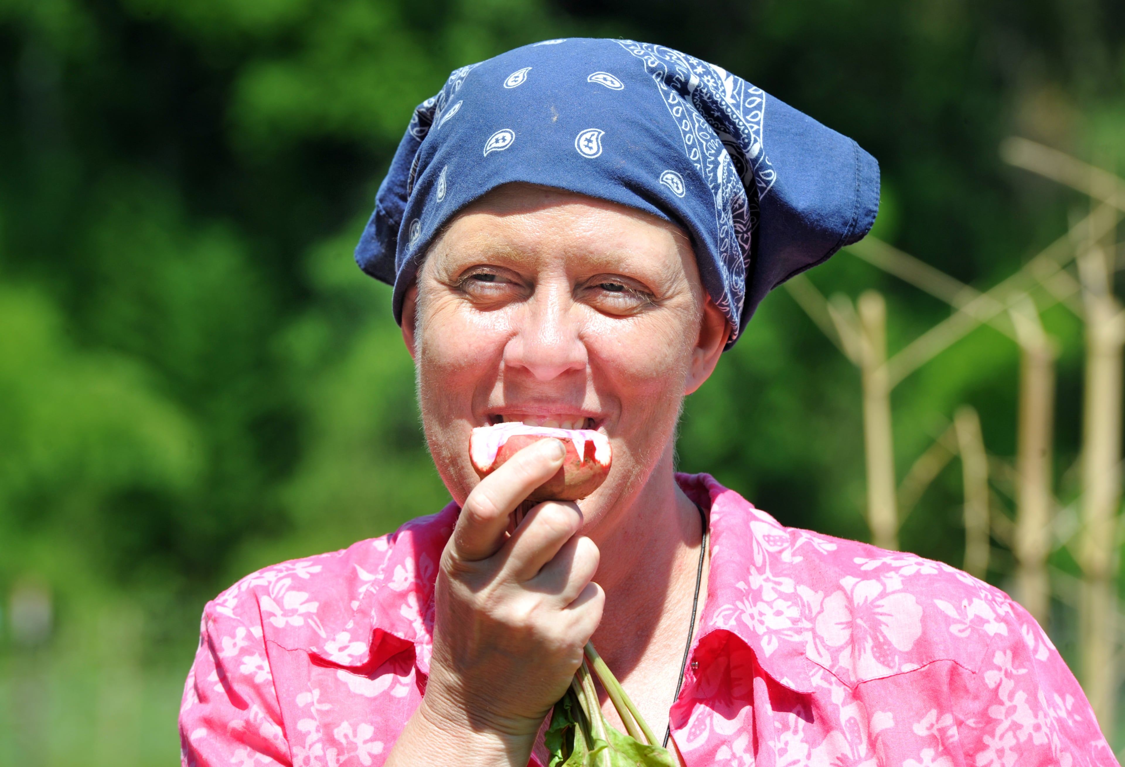 Susan Pavlin, founder of Global Growers Network, takes a bite of beet at Bamboo Creek Farm in Stone Mountain on Saturday, June 14, 2014. HYOSUB SHIN / HSHIN@AJC.COM
