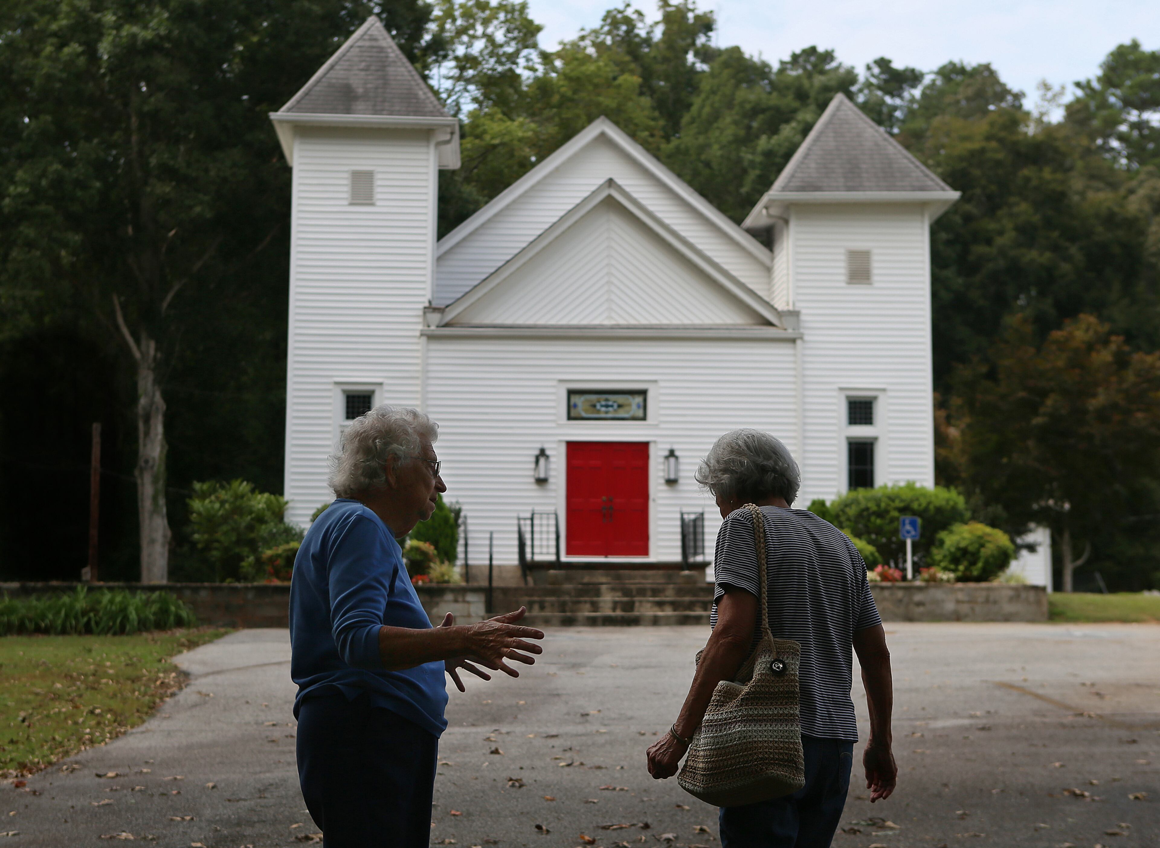 Chruch members Auverne McGinnis (left), the unofficial church historian, and Thelma Harvey (right) talk about the early history of the Campbellton United Methodist Church and the upcoming nearby TomorrowWorld Festival on Wednesday, Sept. 18, 2013, in Fairburn.
