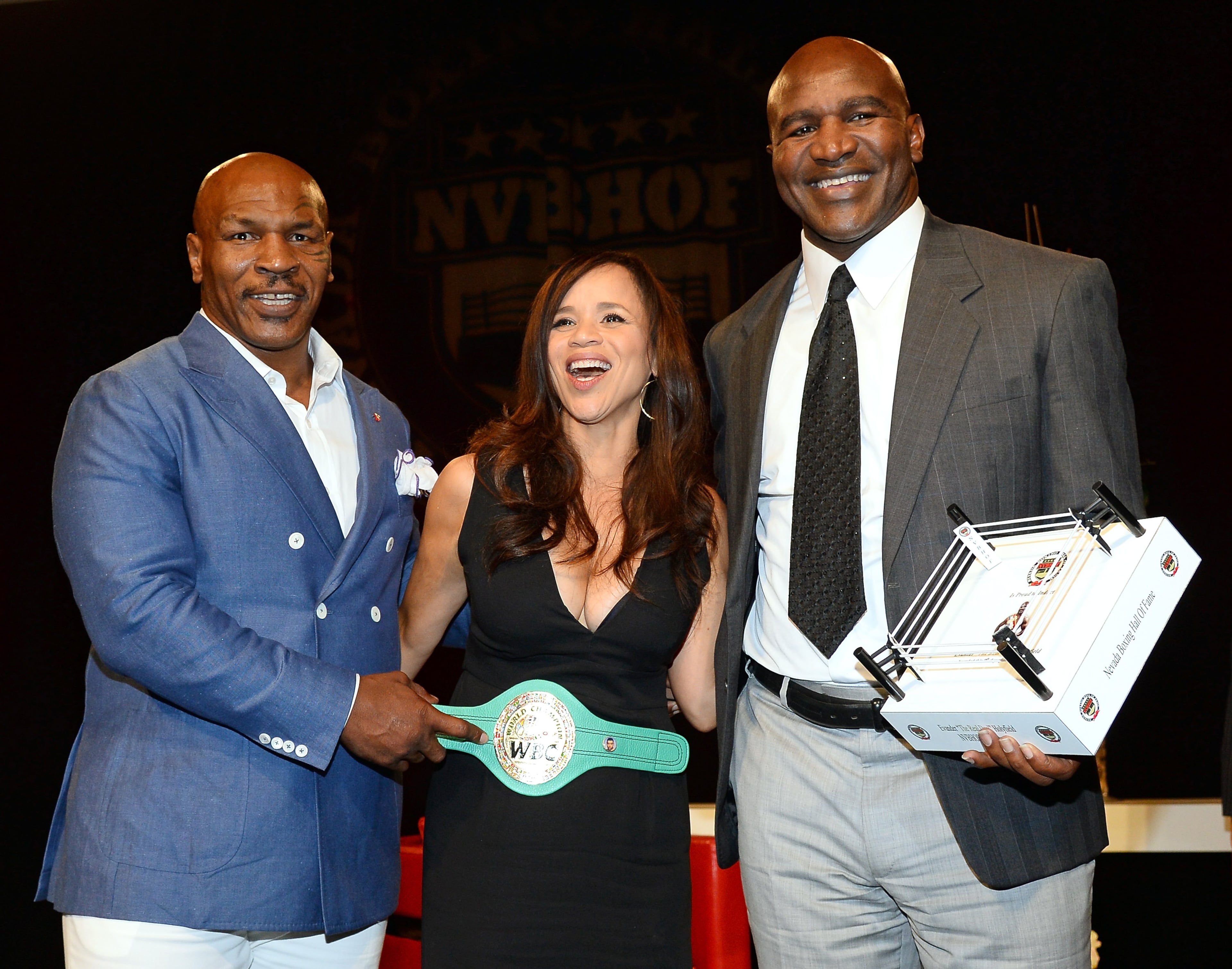 LAS VEGAS, NV - AUGUST 09: (L-R) Former boxer Mike Tyson, actress and emcee Rosie Perez and former boxer Evander Holyfield pose onstage after Tyson inducted Holyfield into the Nevada Boxing Hall of Fame at the second annual induction gala at the New Tropicana Las Vegas on August 9, 2014 in Las Vegas, Nevada. (Photo by Ethan Miller/Getty Images)