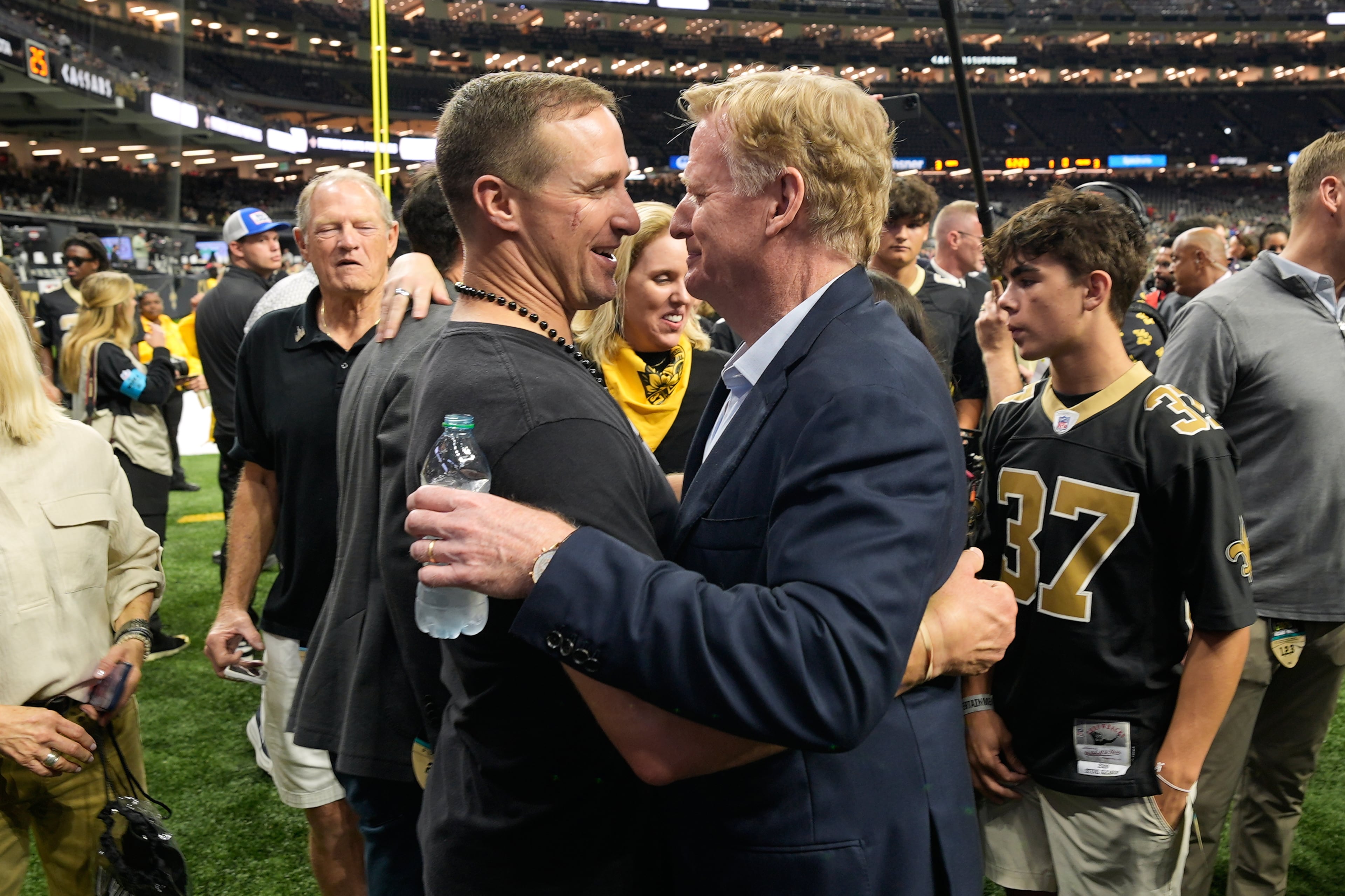 Former New Orleans Saints quarterback Drew Brees (center left) greets NFL Commissioner Roger Goodell before an NFL football game between the Saints and the Atlanta Falcons in New Orleans, Monday, Oct. 5, 2026. (Gerald Herbert/AP)