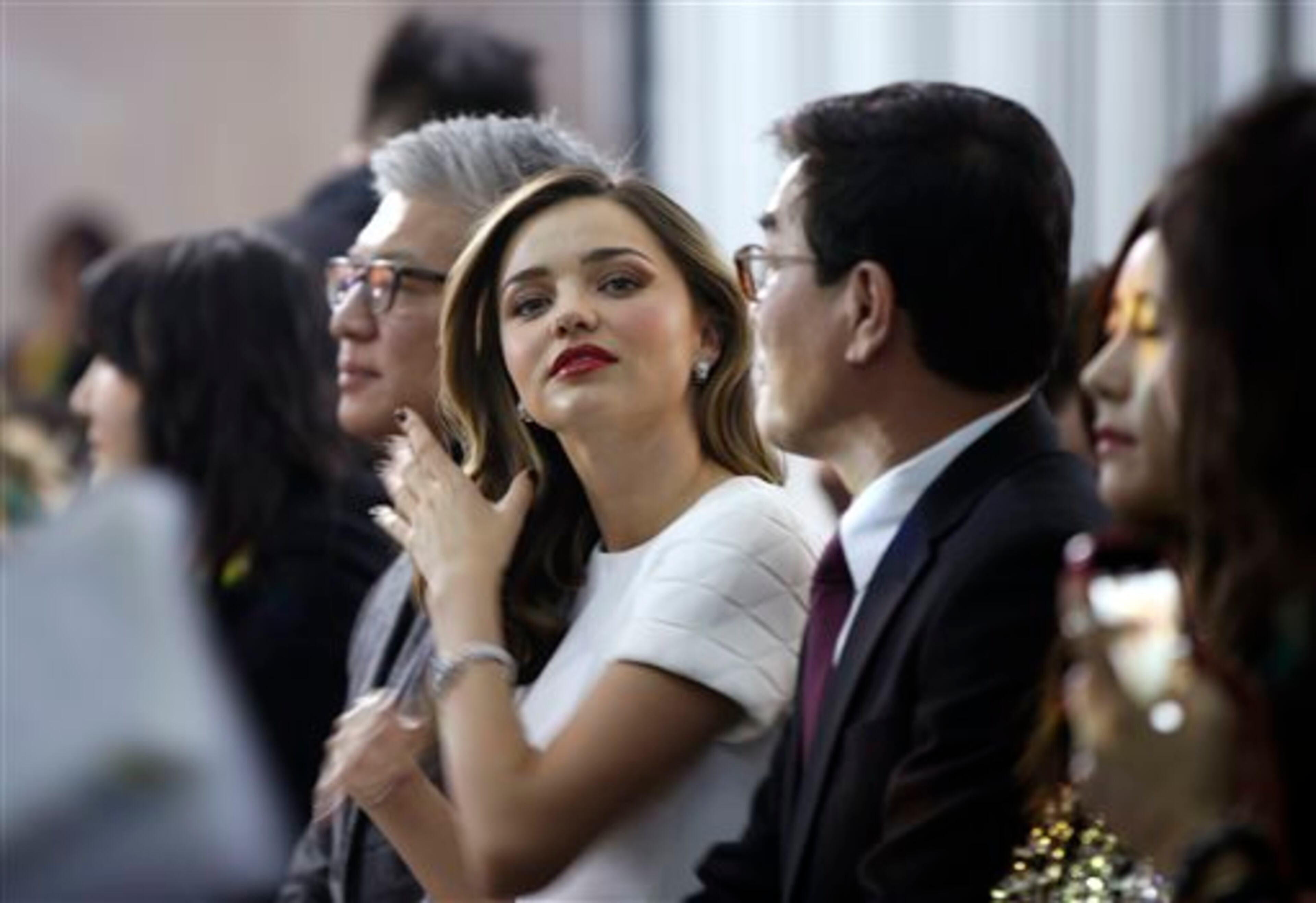 Supermodel Miranda Kerr adjusts her hair during the presentation of the GS Shop Lingerie show featuring Spanx, Wonderbra, Platex and Anna Sui during Fashion Week Tuesday, Feb. 4, 2014, in New York. (AP Photo/Kathy Willens)