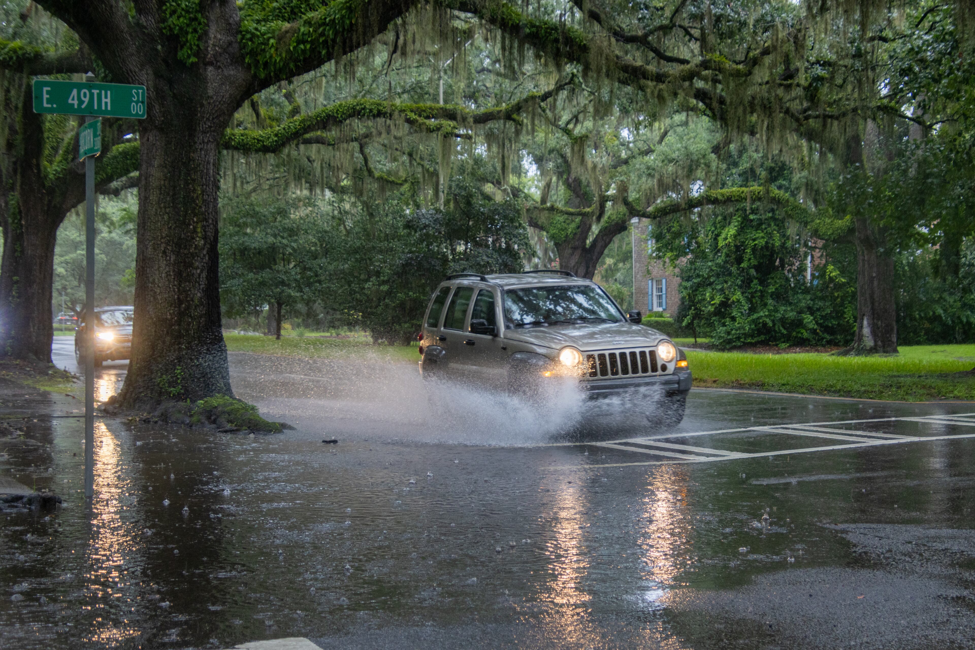 A car drives through a flooded street on Monday, August 5, 2024 in Savannah, GA. (AJC Photo/Katelyn Myrick)