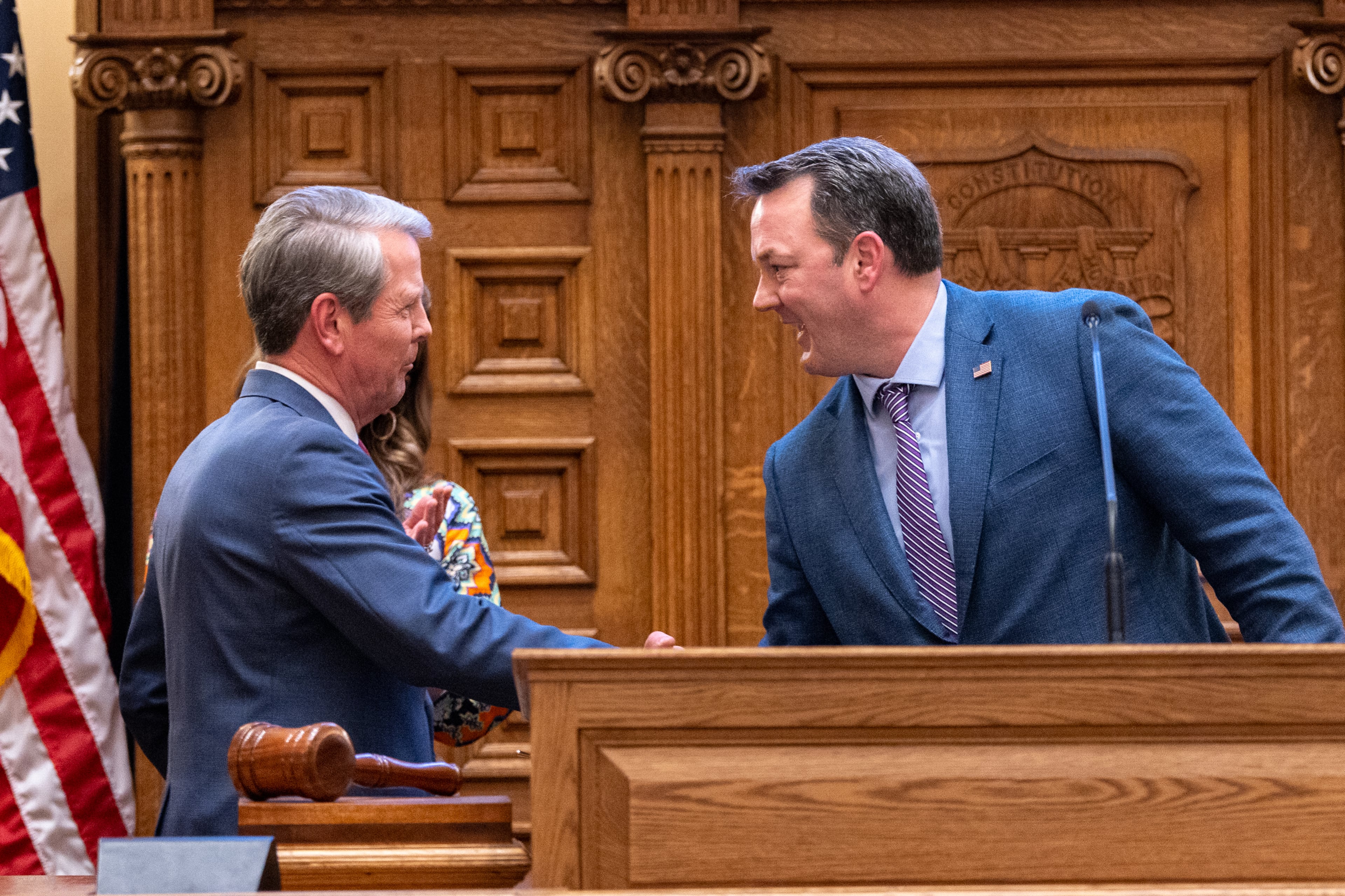 Gov. Brian Kemp (left) and Lt. Gov. Burt Jones shake hands before the governor makes his final speech at the Senate, on Sine Die, the last day of the legislative session, in April. (Arvin Temkar/AJC)