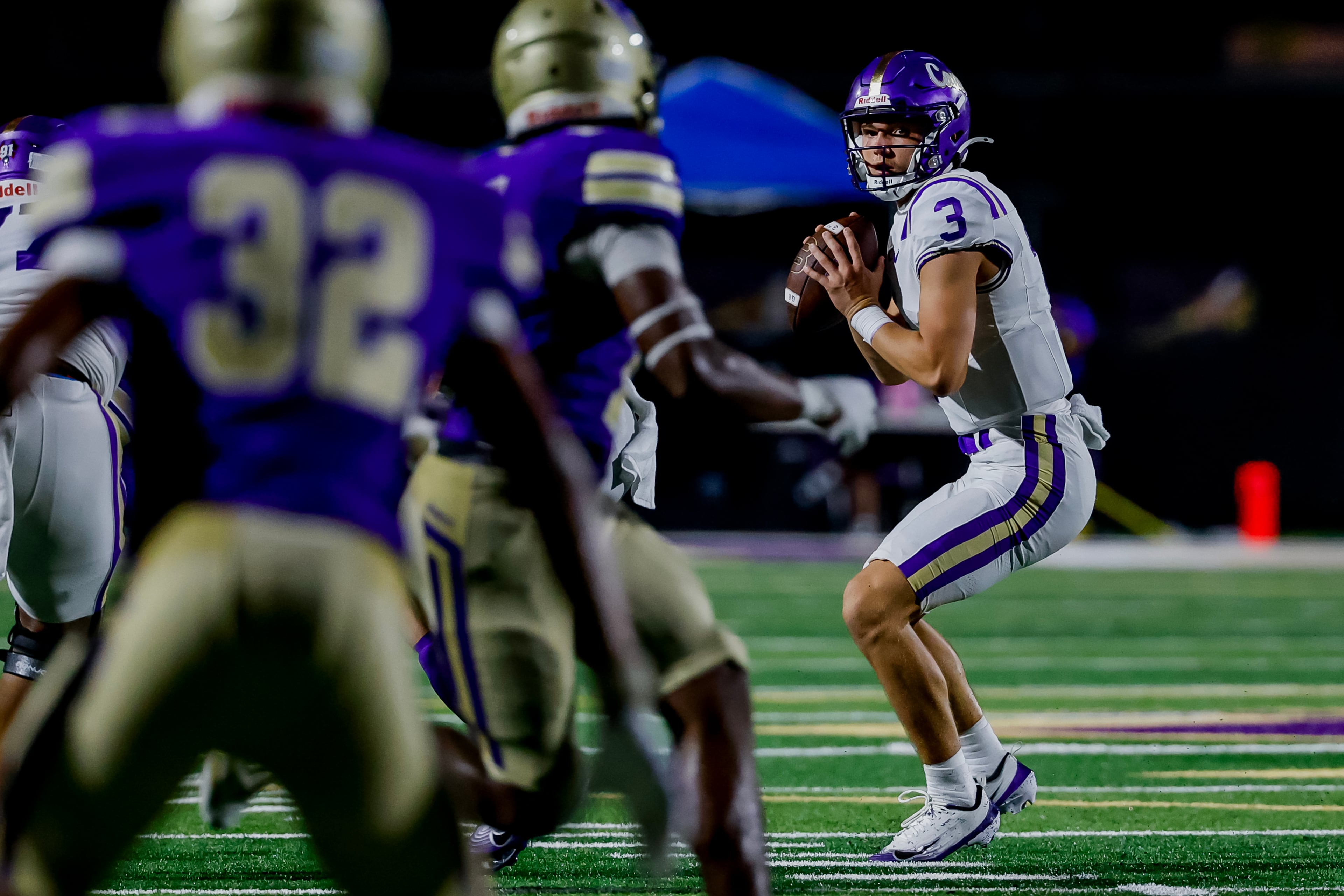Cartersville quarterback Harris Turner (right) drops back against Hiram during the first half of their game on Friday, Aug. 21, 2026, in Hiram. (Erik S. Lesser for the AJC)