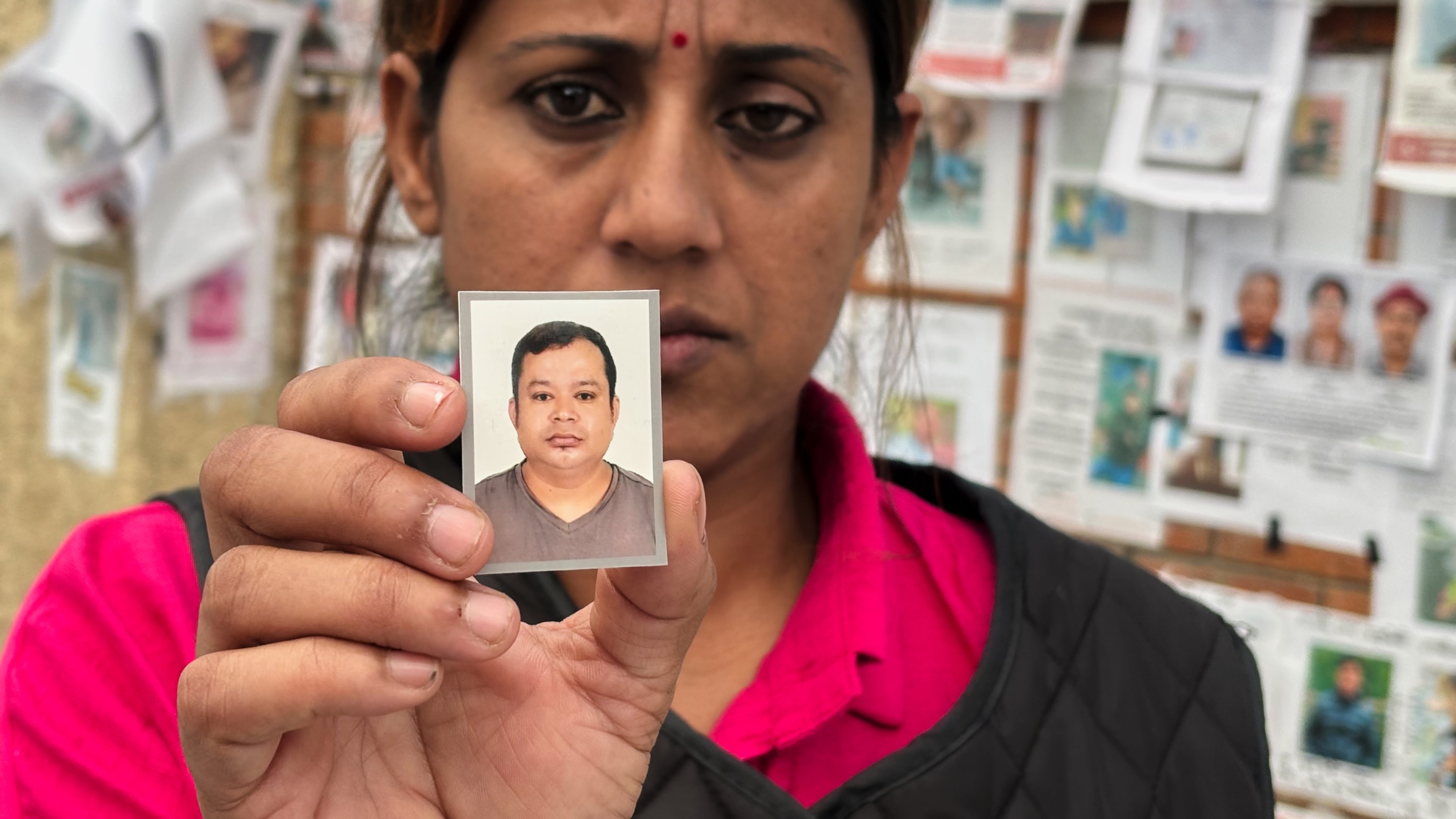 In this photo taken with a smartphone, Usha Khatri shows a photo of her husband Indra Bahadur who has been missing since last month's flood outside Tribhuvan University Teaching Hospital, in Kathmandu, Nepal, Thursday, Sept. 17, 2026. (AP photo/Upendra Man Singh)