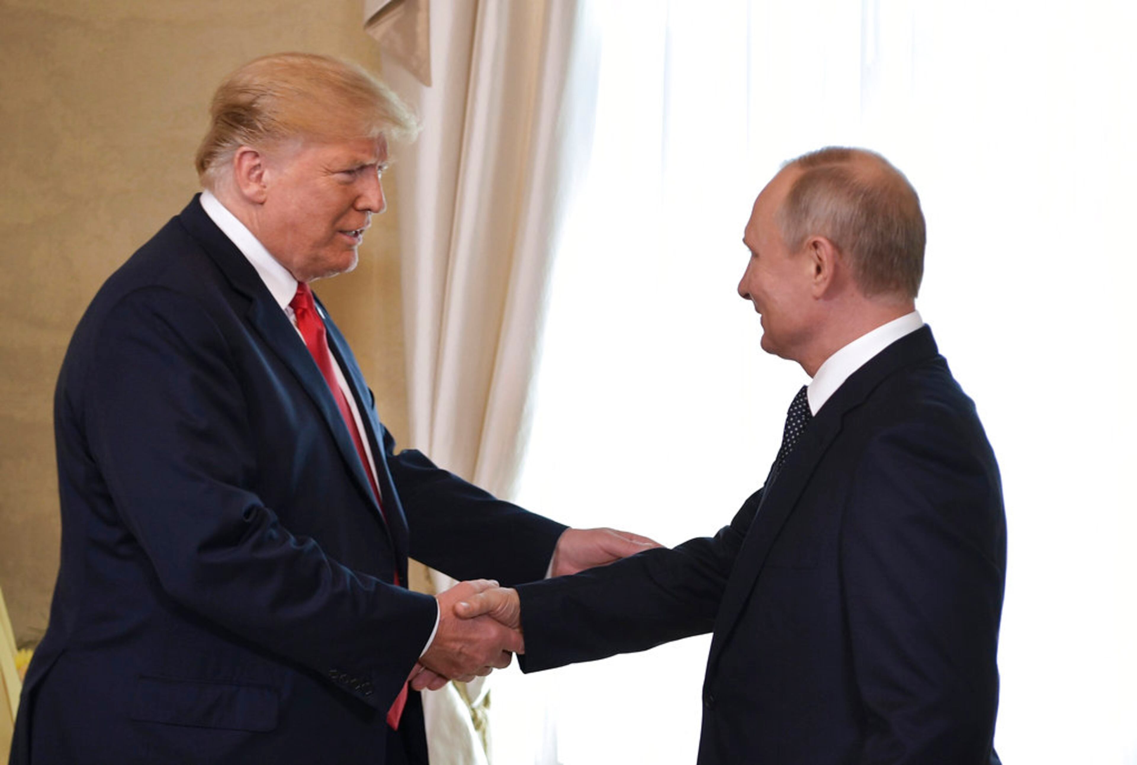 U.S. President Donald Trump and Russian President Vladimir Putin, right, welcome each other at the Presidential Palace in Helsinki, Finland, Monday, July 16, 2018 prior to Trump's and Putin's one-on-one meeting in the Finnish capital. (Alexei Nikolsky, Sputnik, Kremlin Pool Photo via AP)