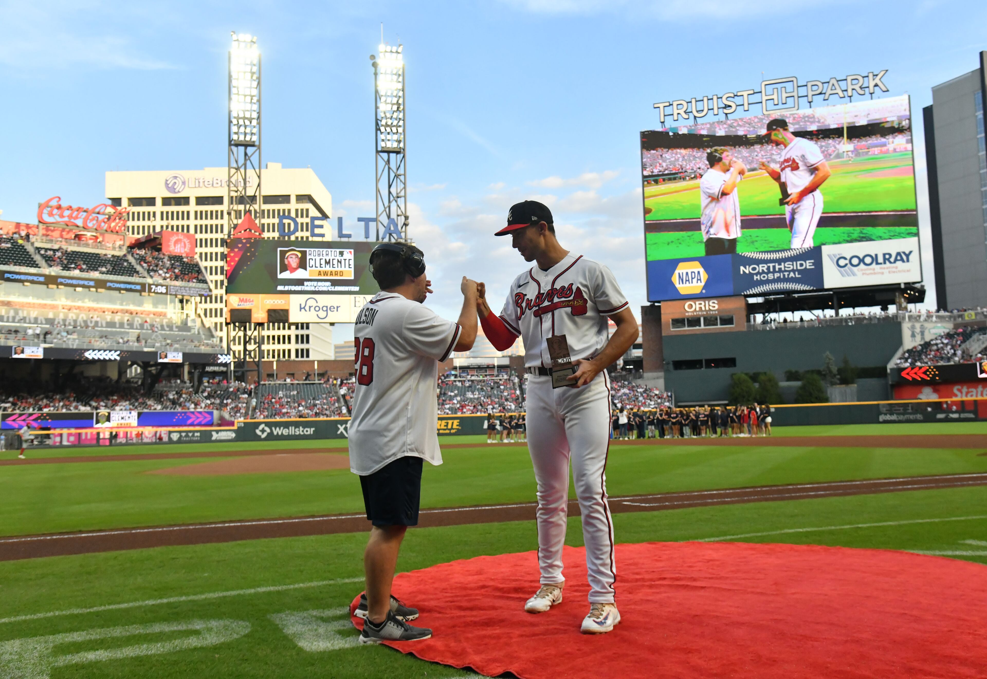 Atlanta Braves first baseman Matt Olson, with friend Reece Blankenship, who has nonverbal autism, is recognized as a Roberto Clemente Award nominee during a pregame ceremony. (Hyosub Shin / Hyosub.Shin@ajc.com)