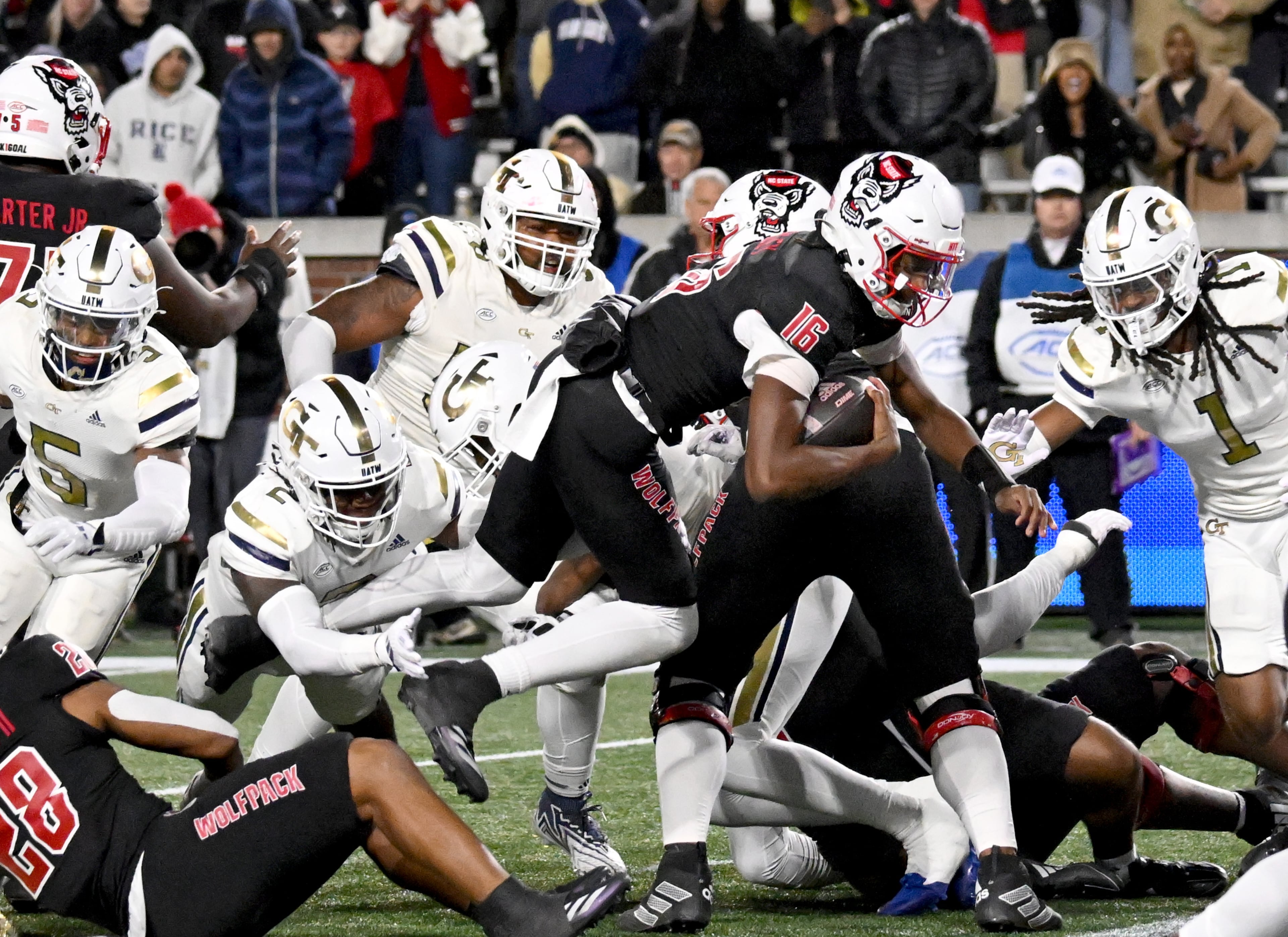 North Carolina State quarterback CJ Bailey (16) leaps for a touchdown during the fourth quarter in an NCAA college football game at Georgia Tech's Bobby Dodd Stadium, Thursday, November 21, 2024, in Atlanta. Georgia Tech won 30-29 over North Carolina State. (Hyosub Shin / AJC)