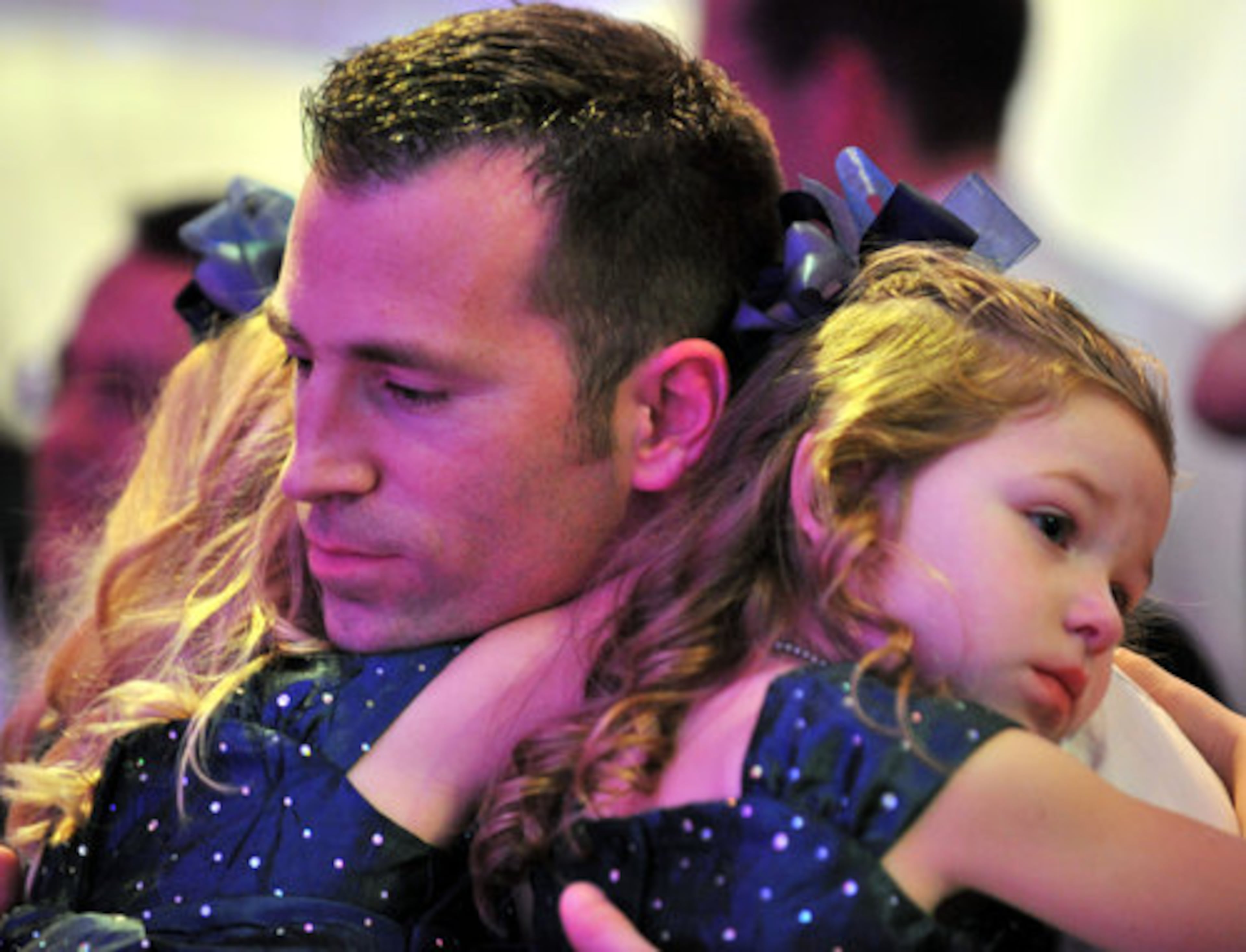 Zach Thomas, of Rockmart, hugs his two daughters Louci (left), 6, and Annabelle, 4, during the "My Princess Dance" - the 6th Annual Daddy Daughters' Dance at InterContinental Buckhead on Saturday, Jan. 29, 2011.