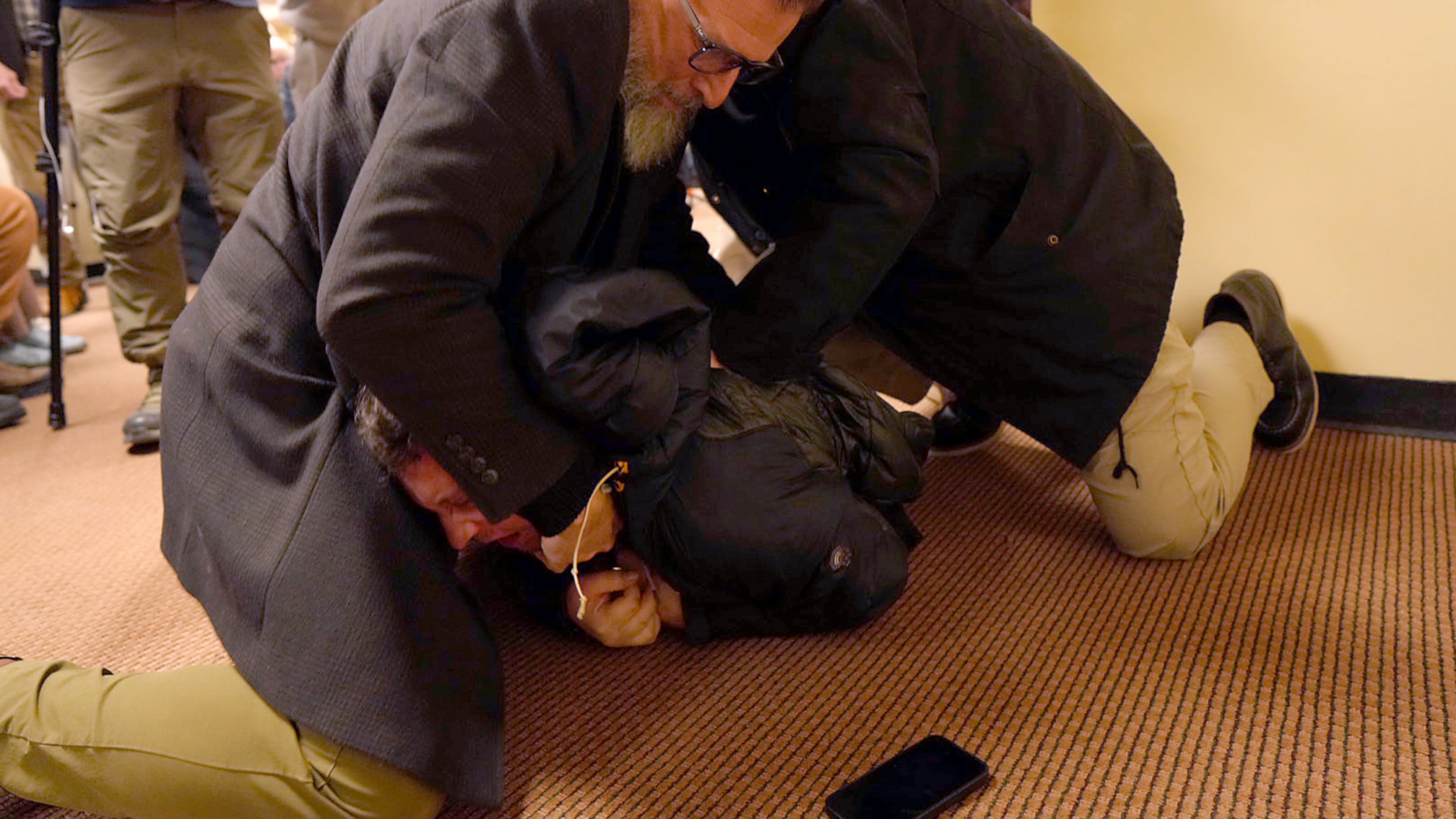 A man is tackled to the ground after spraying an unknown substance on U.S. Rep. Ilhan Omar, D-Minn., during a town hall on Tuesday, Jan. 27, 2026, in Minneapolis. (Richard Tsong-Taatarii/Star Tribune via AP)