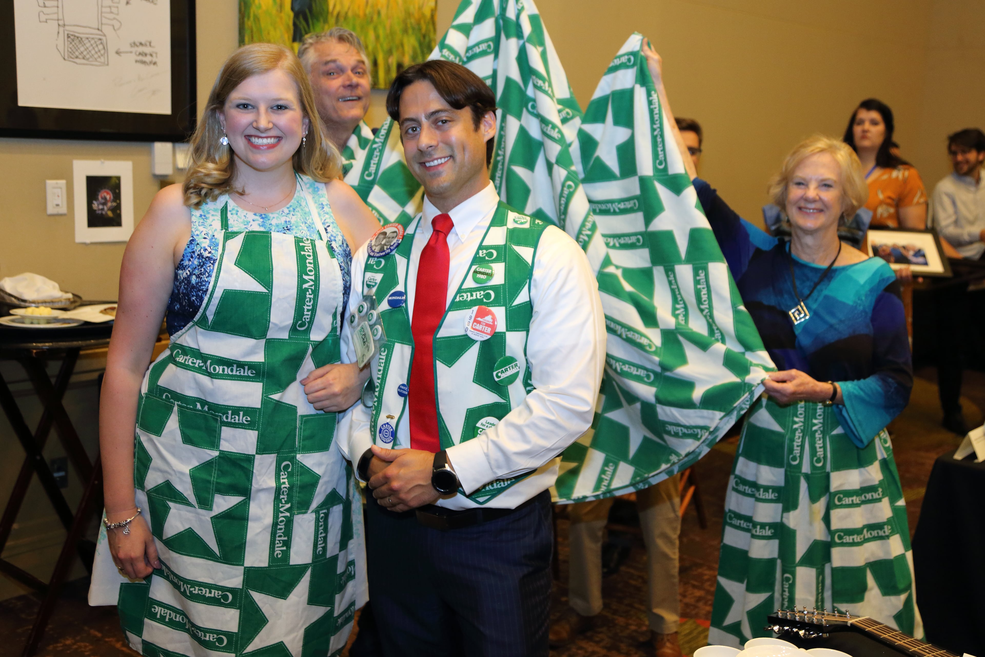 Volunteers with The Carter Center model 1980 Carter-Mondale memorabilia at Saturday’s $4.2 million auction. The items, including a vest, apron and skirt, sold for $1,000.