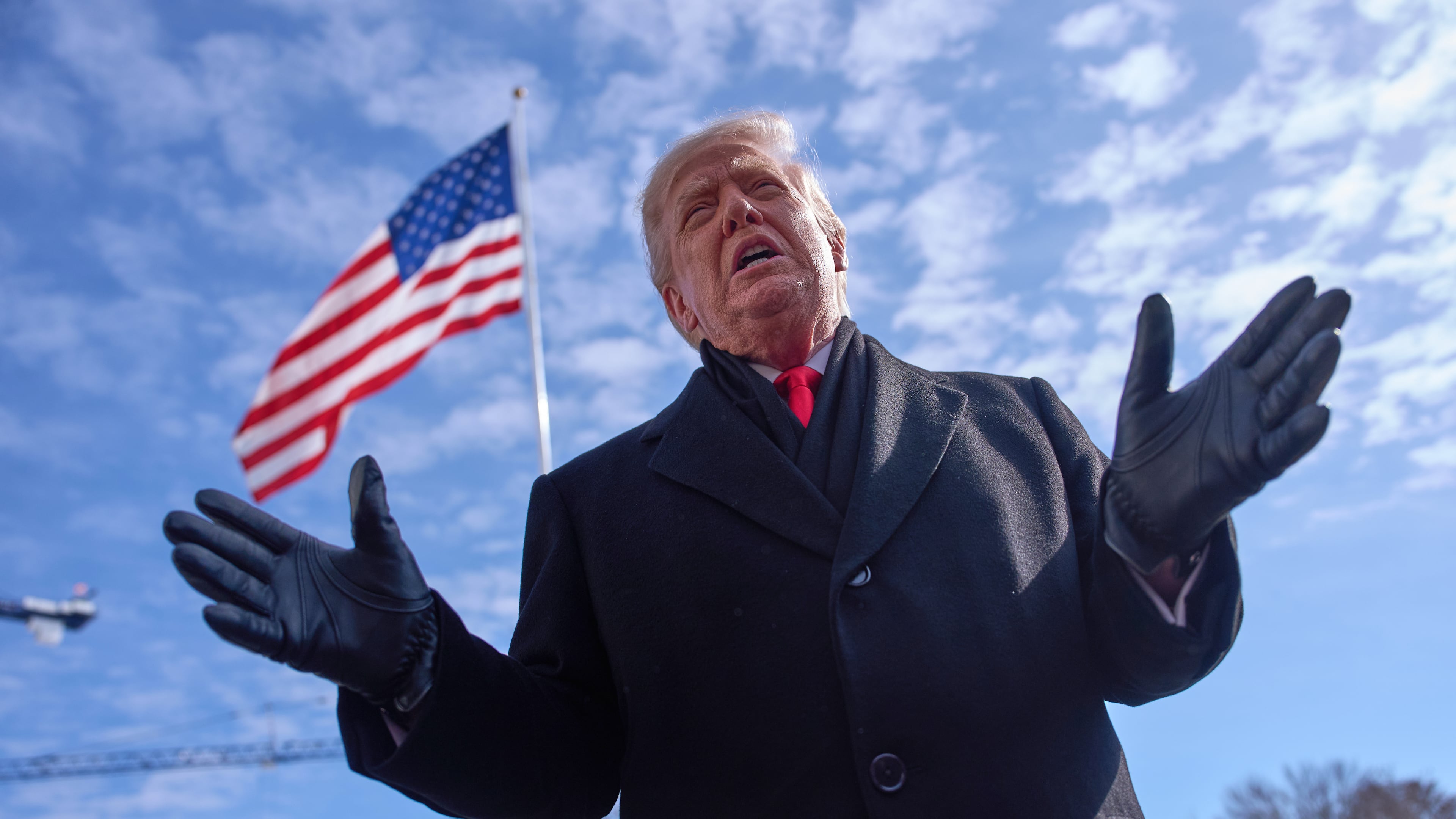 President Donald Trump speaks with reporters before boarding Marine One on South Lawn of the White House, Tuesday, Jan. 27, 2026, in Washington. (AP Photo/Evan Vucci)