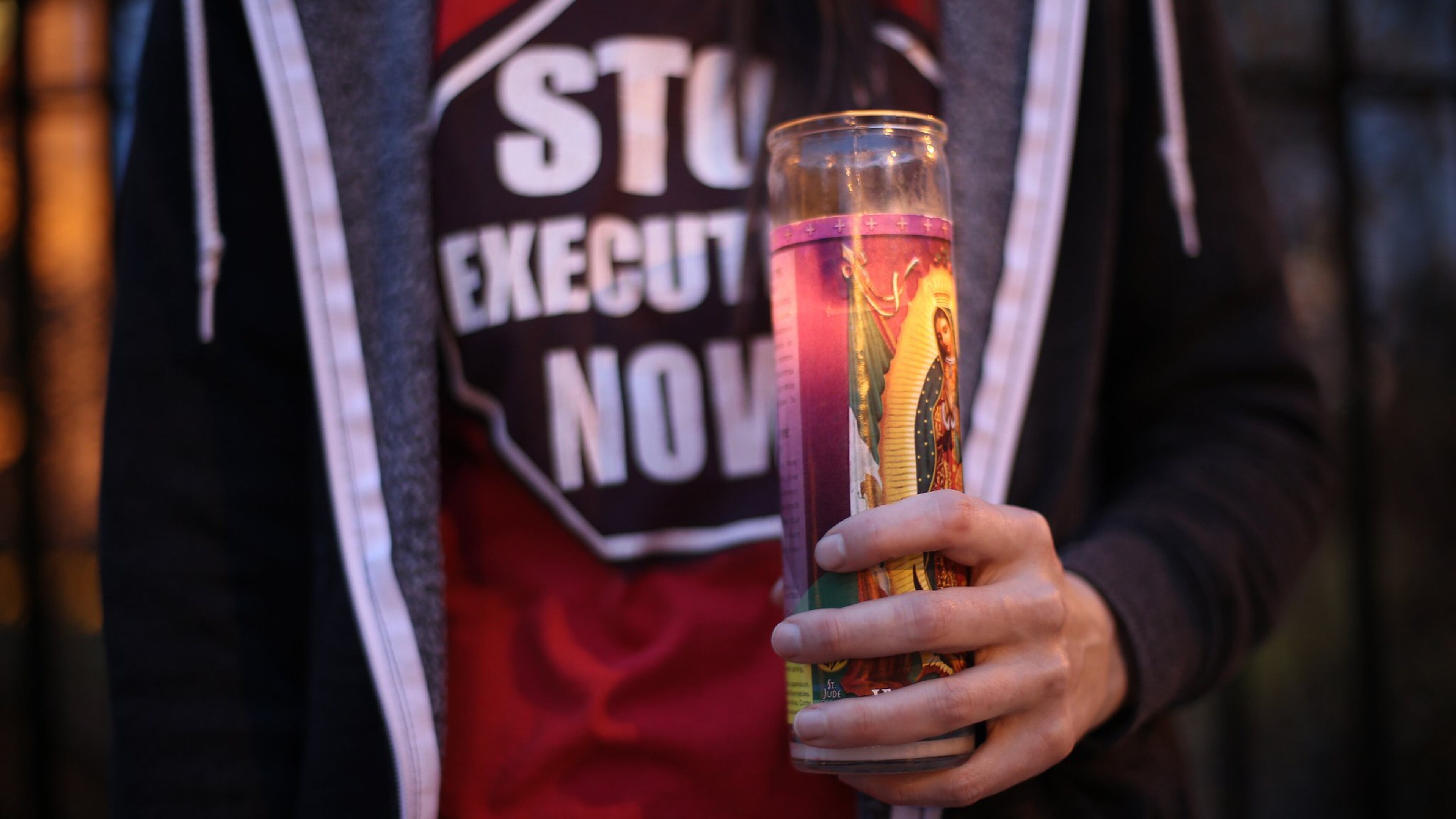 Ashley Petty holds a candle at a protest against the death penalty on March 2, 2015, on the steps of the state Capitol in Atlanta. BEN GRAY / BGRAY@AJC.COM