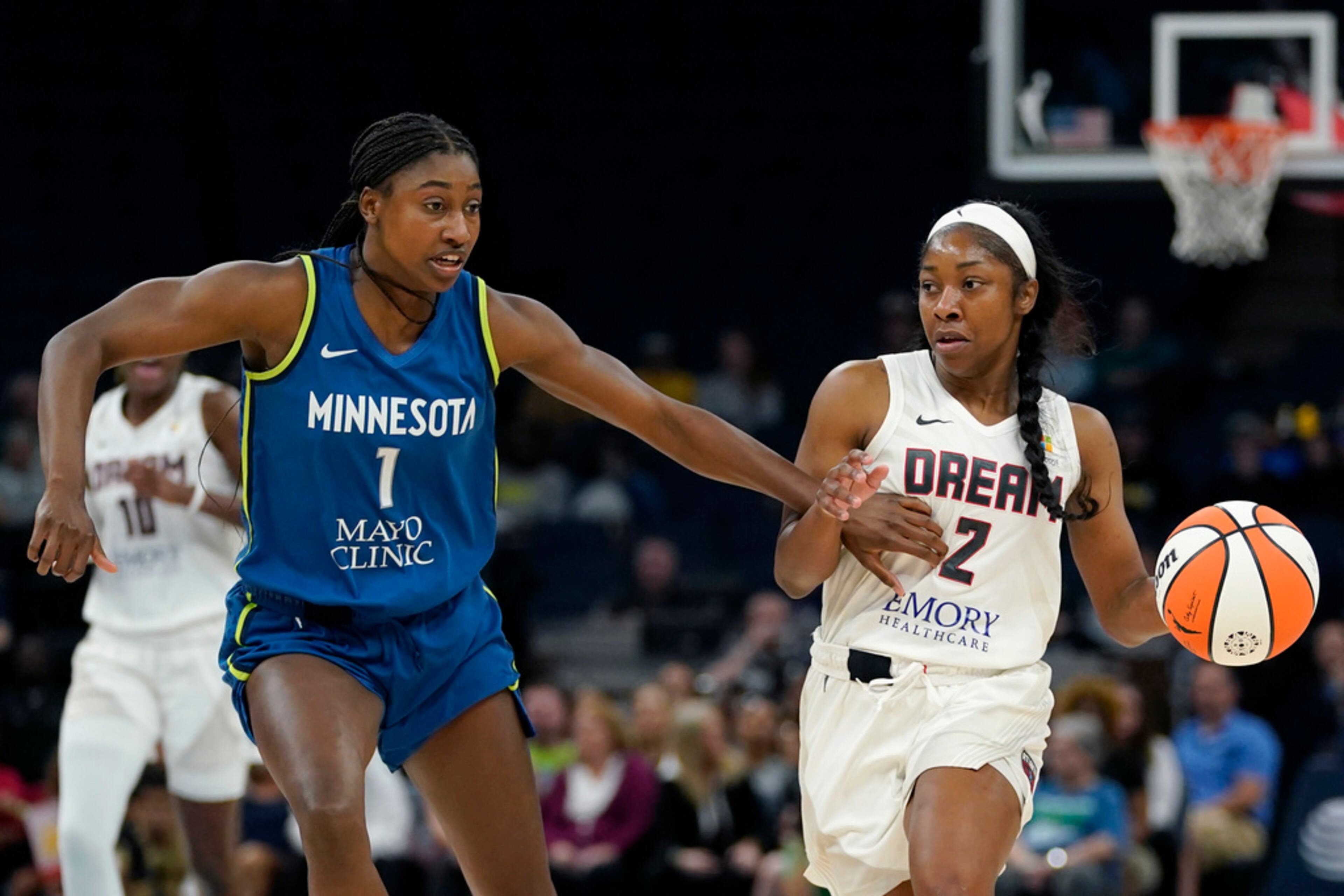 Atlanta Dream guard Aari McDonald (2) works toward the basket while defended by Minnesota Lynx guard Diamond Miller (1) during the first half of a WNBA basketball game Friday, Sept. 1, 2023, in Minneapolis. (AP Photo/Abbie Parr)