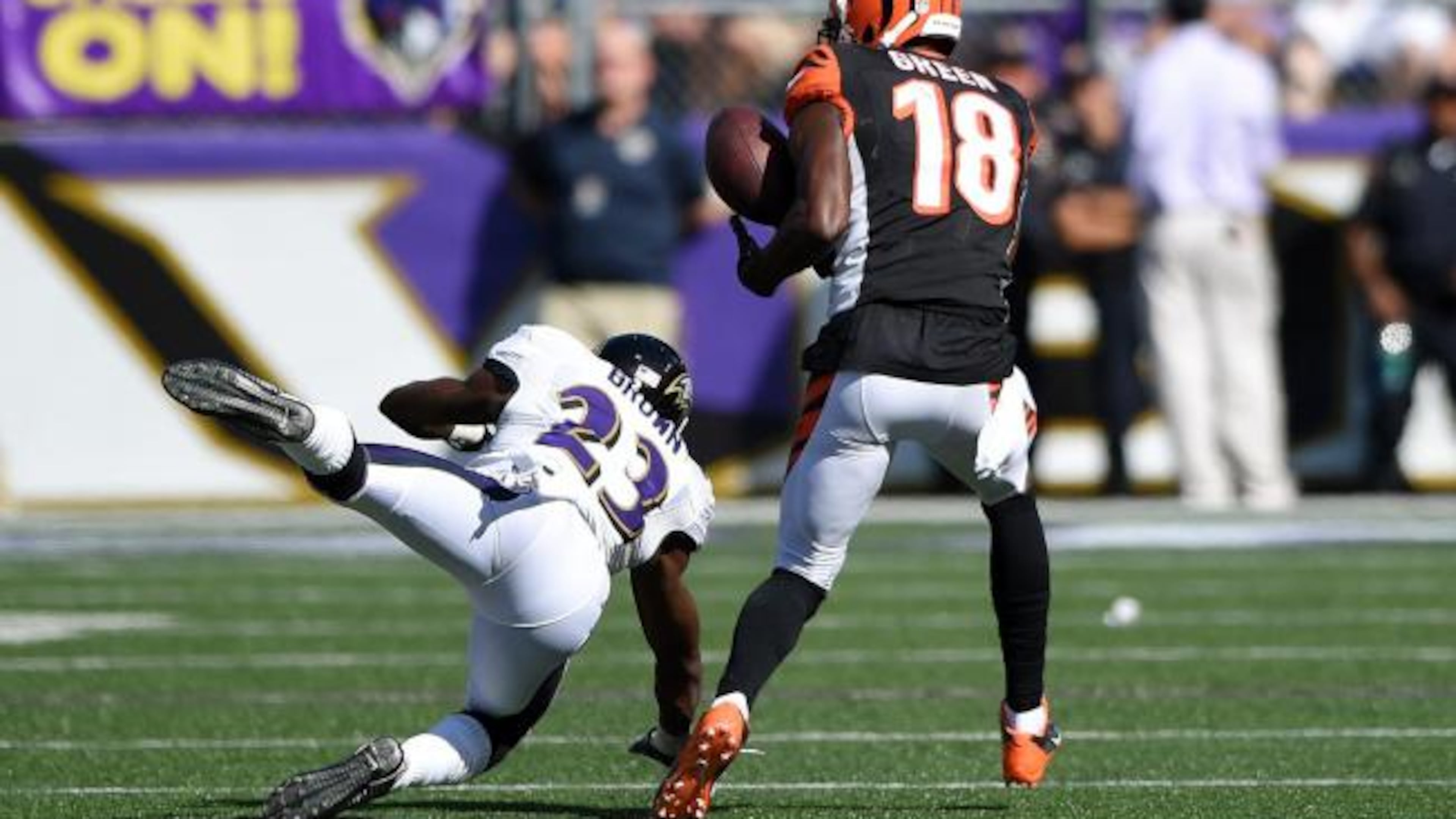Cincinnati Bengals wide receiver A.J. Green (18) catches a 77-yard touchdown pass under pressure from Baltimore Ravens defensive back Chykie Brown (23) during the second half of an NFL football game in Baltimore, Md., Sunday, Sept. 7, 2014. The Bengals defeated the Ravens 23-16. (AP Photo/Nick Wass)