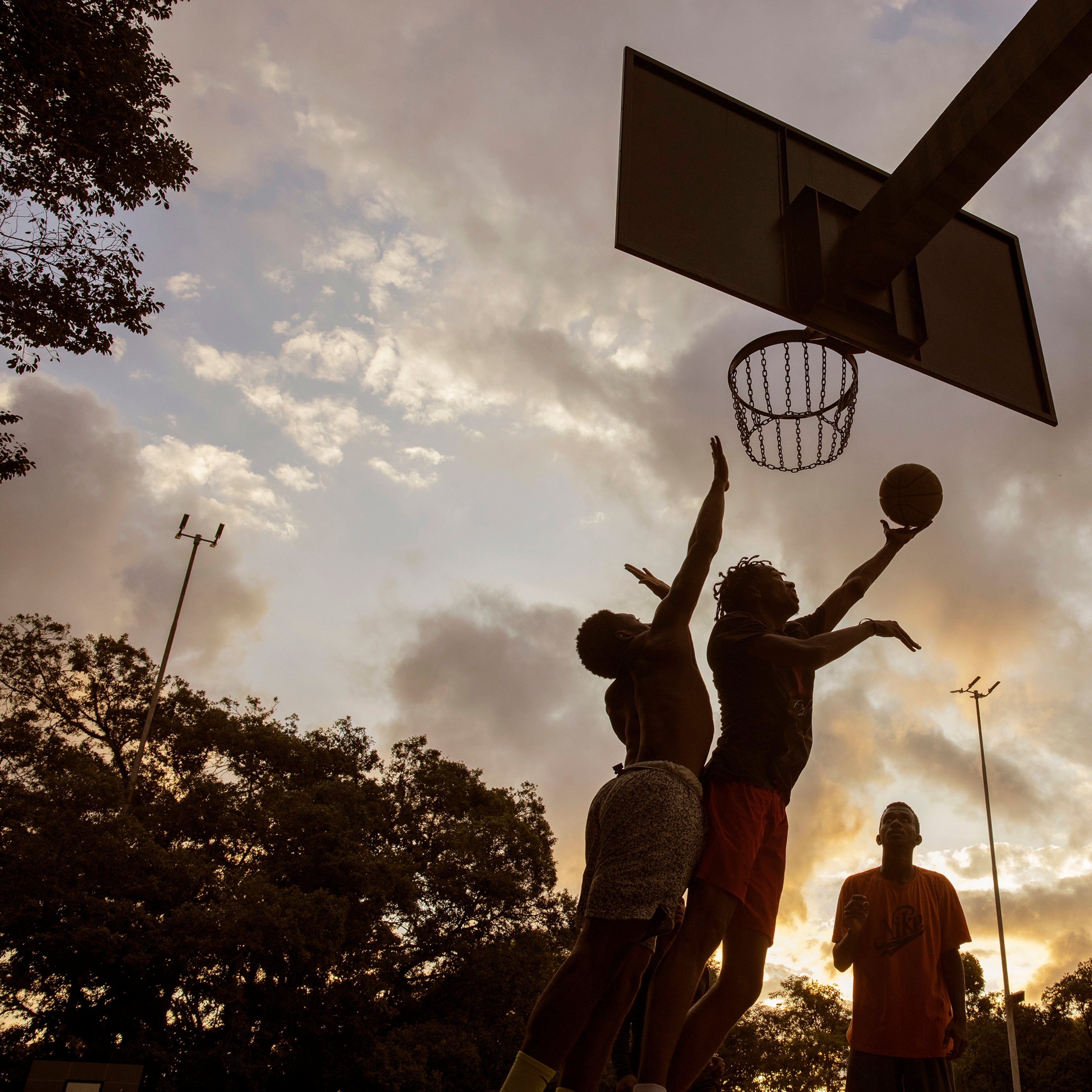 Men play basketball in So Paulo, Nov. 6, 2022. (Victor Moriyama/The New York Times)