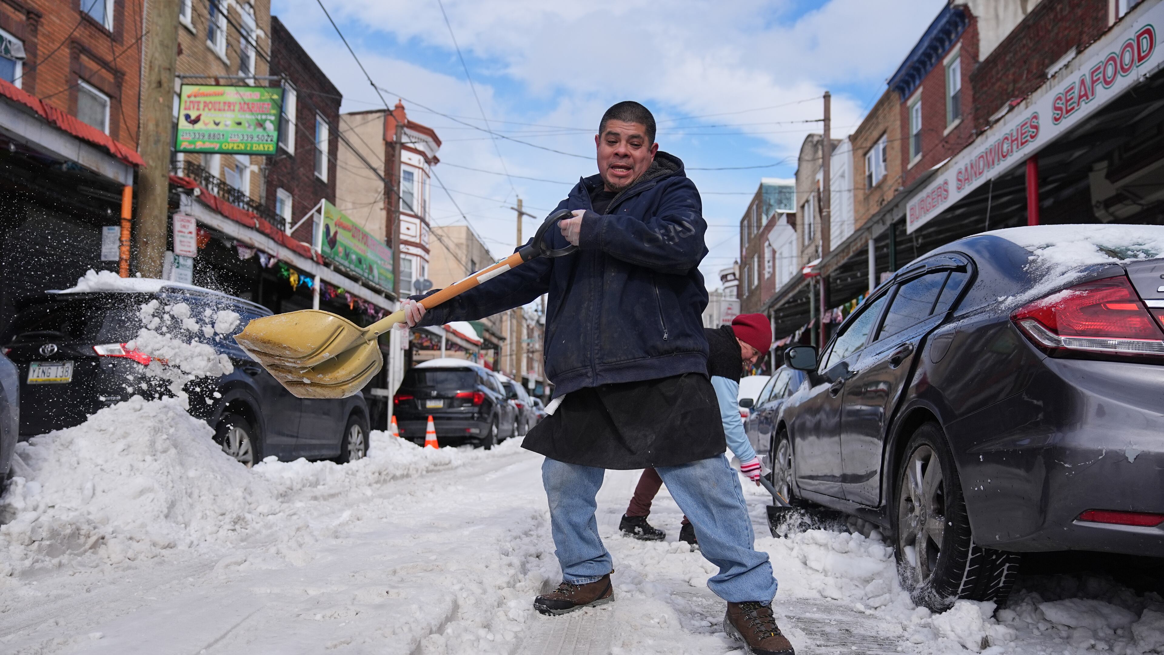 Gilberto Hernandez shovels snow in the aftermath of a winter storm in Philadelphia, Monday, Jan. 26, 2026. (AP Photo/Matt Rourke)