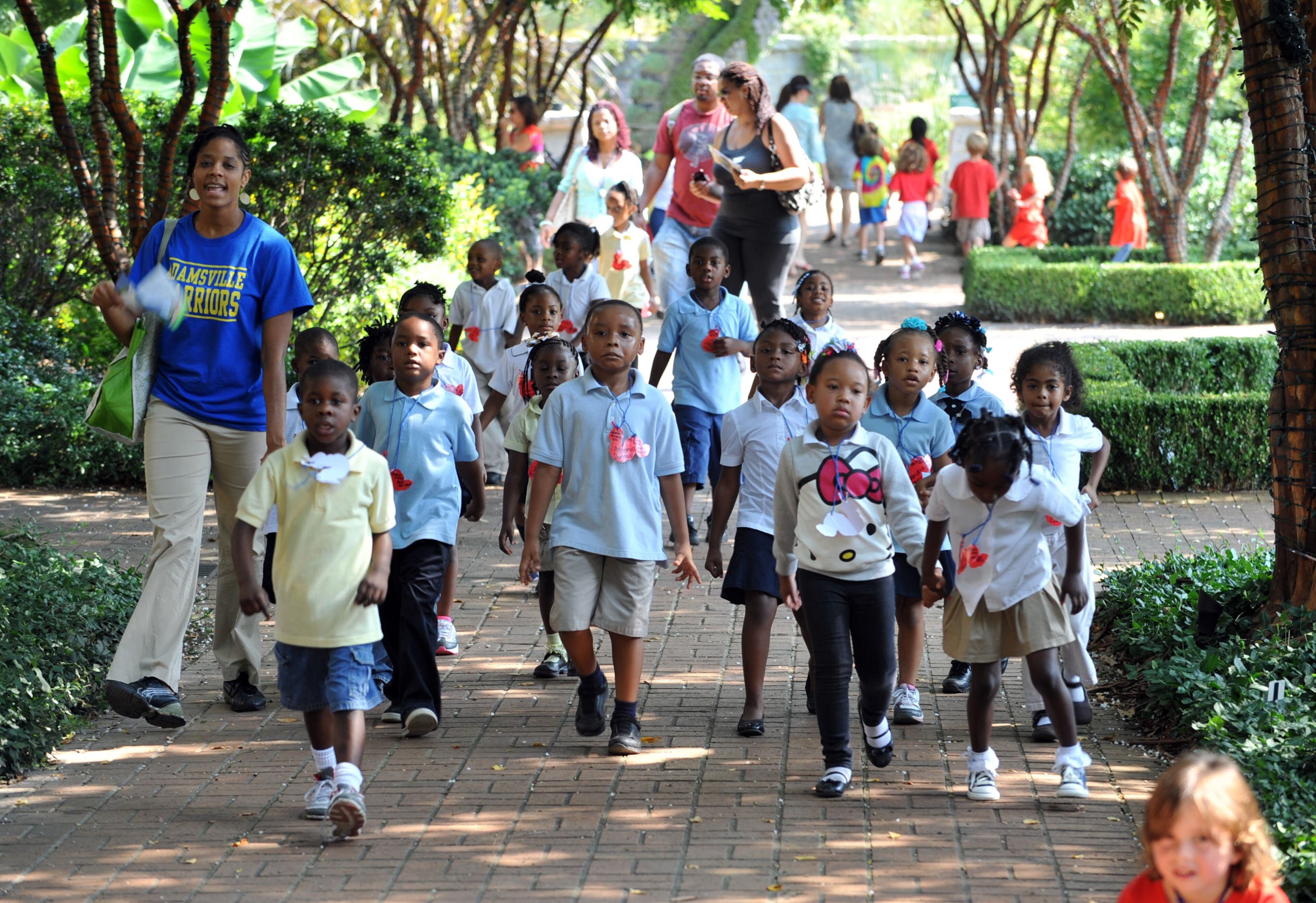Students from Adamsville Elementary head down the walk towards the Fuqua Conservatory.