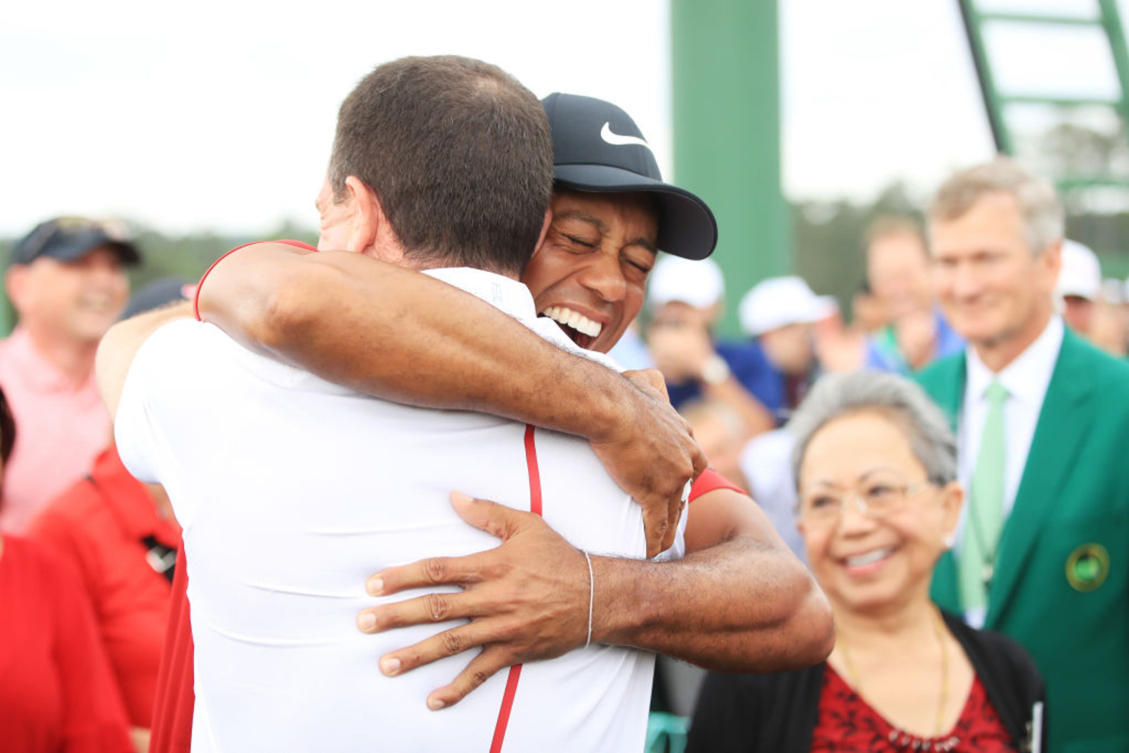 AUGUSTA, GEORGIA - APRIL 14: Tiger Woods of the United States embraces his manager Mark Steinberg as he comes off the 18th hole in celebration of his win during the final round of the Masters at Augusta National Golf Club on April 14, 2019 in Augusta, Georgia. (Photo by Andrew Redington/Getty Images)