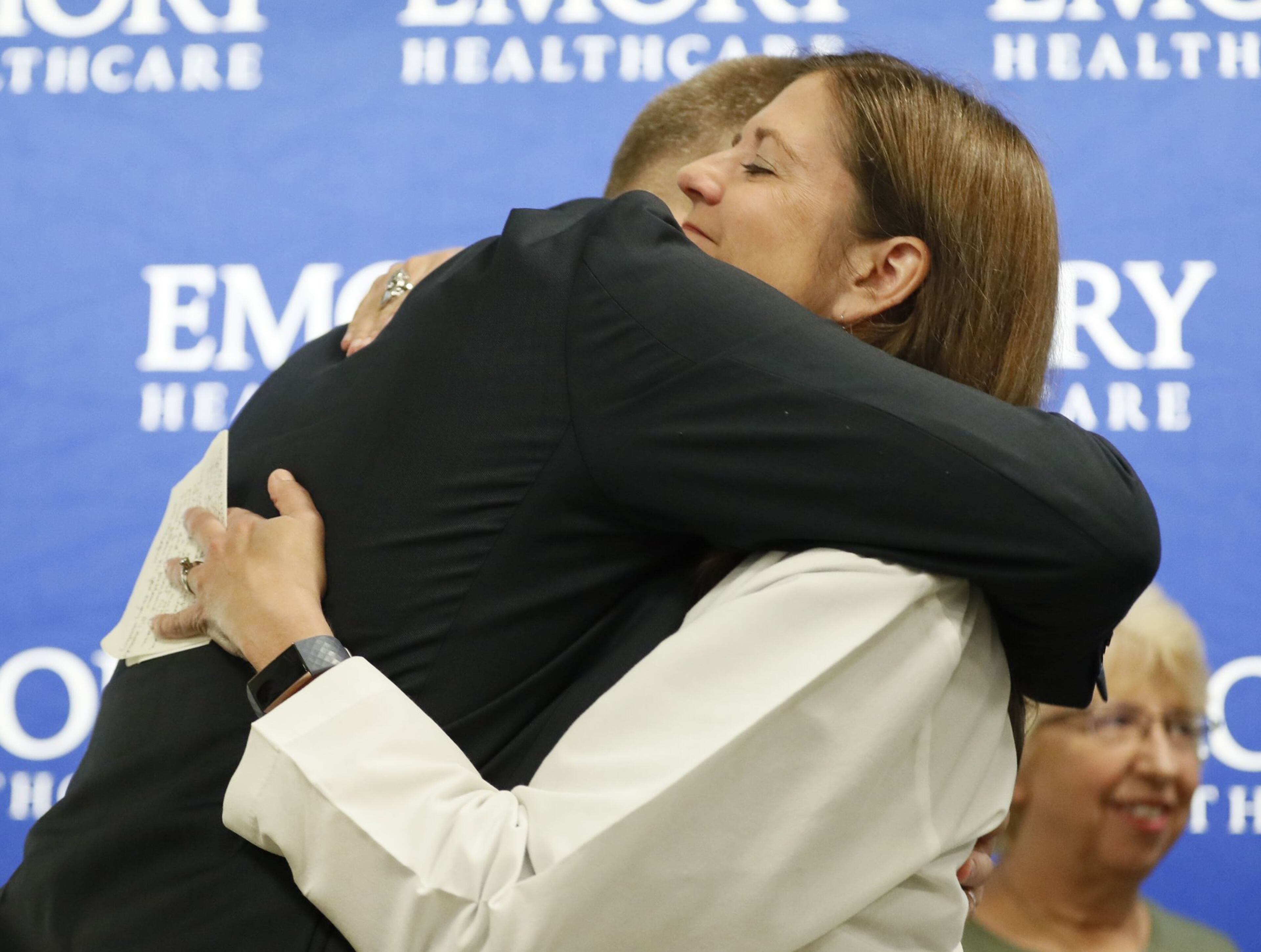 In this file photo, Dr. Colleen Kraft gives Dr. Kent Brantly a hug as he takes the stage to talk with the media on the fifth anniversary of Dr. Brantly’s arrival at Emory University Hospital as the first patient with Ebola virus disease to be treated in the U.S. Kraft was part the university hospital’s Ebola treatment team.robert.andres@ajc.com
