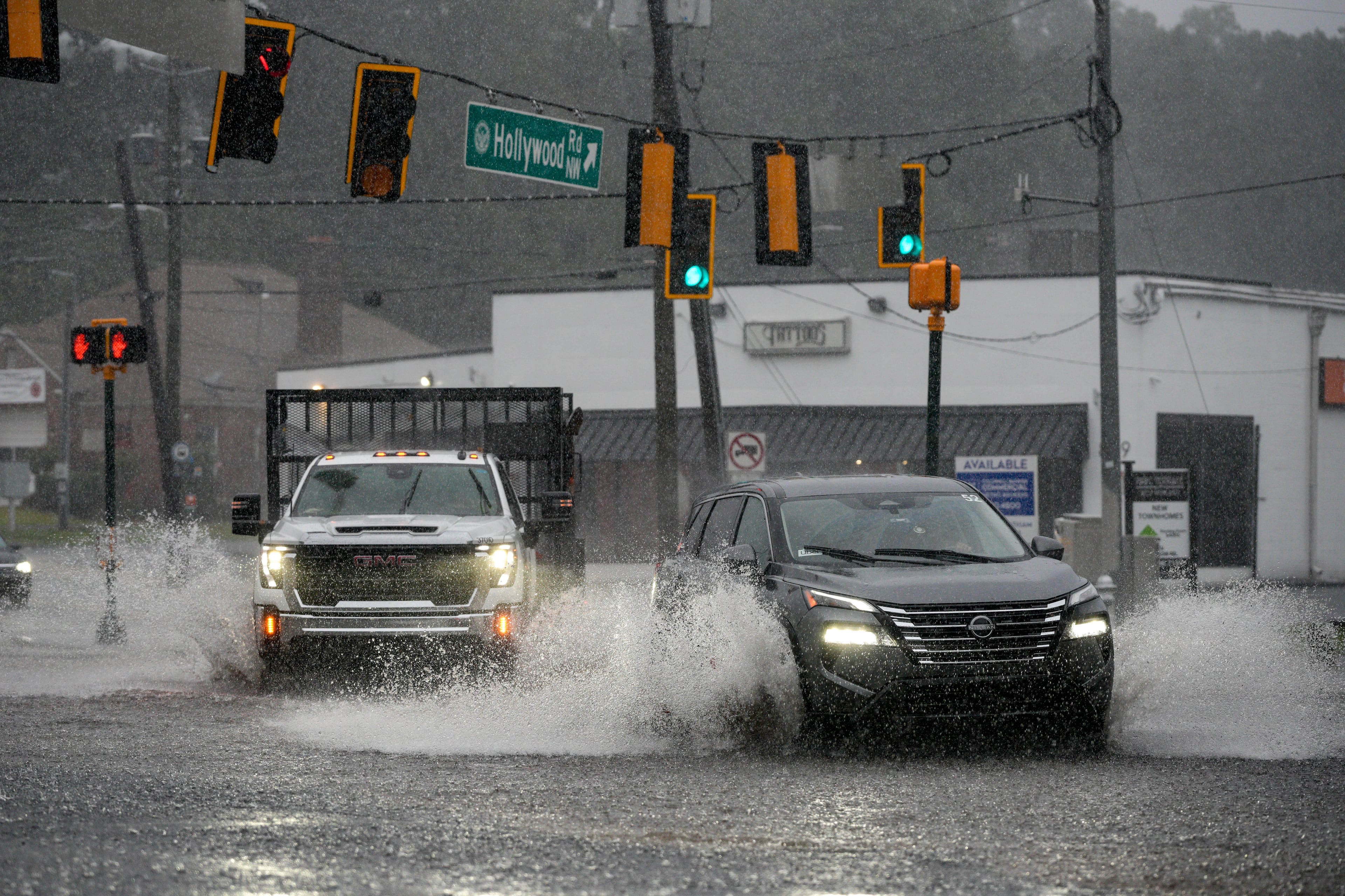 Motorists drive through a flooded street in northwest Atlanta on Saturday, Sept. 12, 2026. (Ben Hendren for The Atlanta Journal-Constitution)