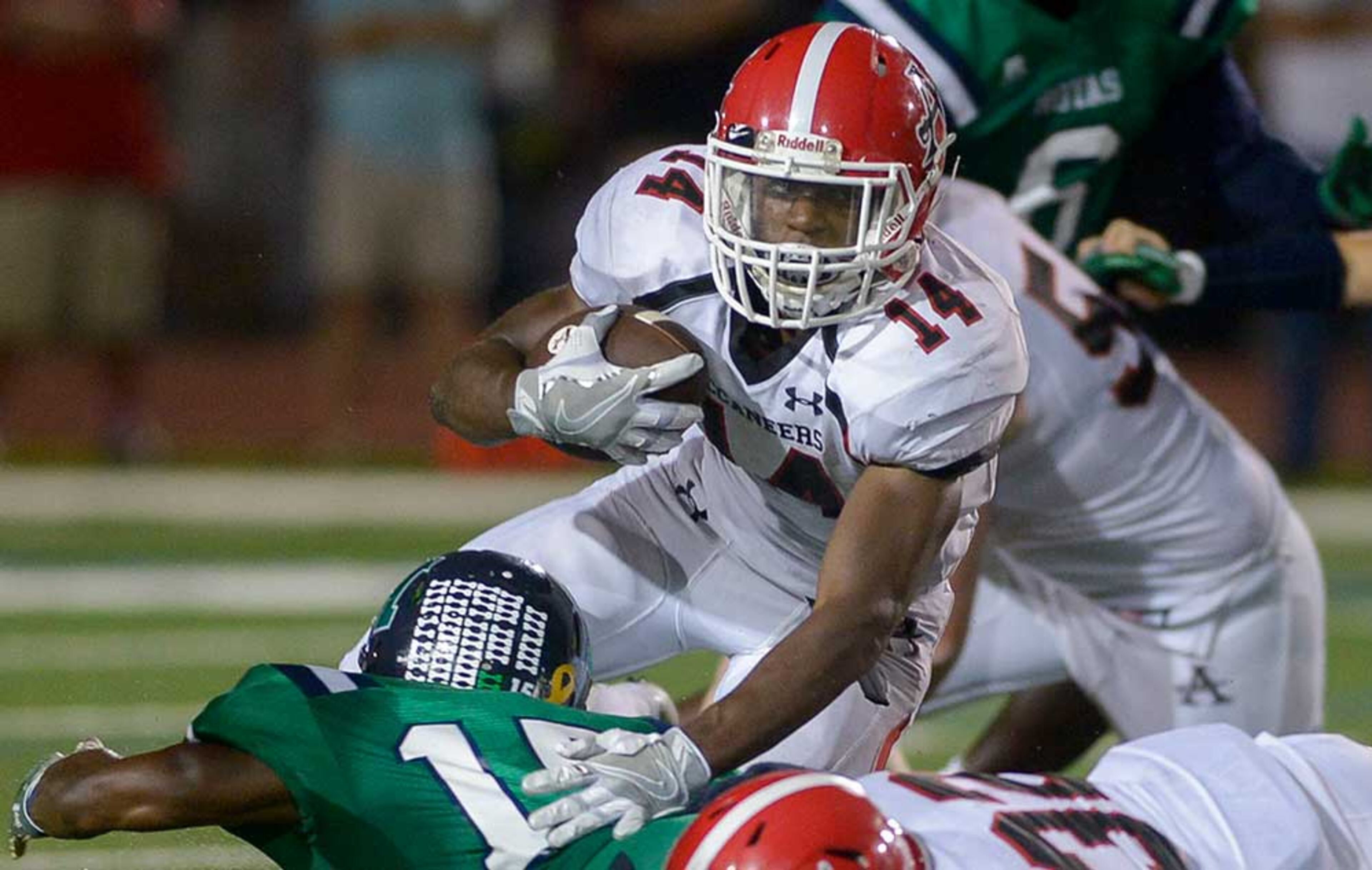 Allatoona senior RB Charles Anderson (14) carries the ball for yardage in the second half of Friday's game.